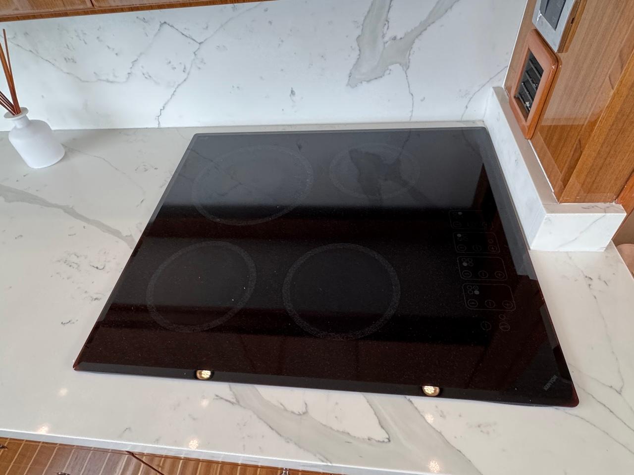 Glass cooktop on marble countertop in 2007 Viking 52 Convertibles yacht kitchen.