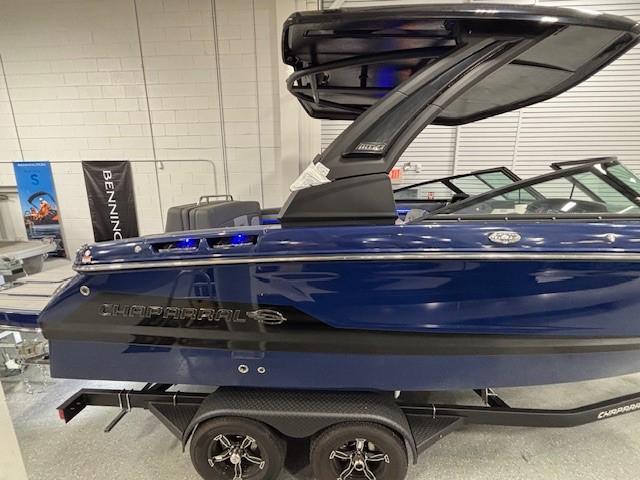 2026 Chaparral SSX 6 boat in showroom, blue exterior, on trailer.