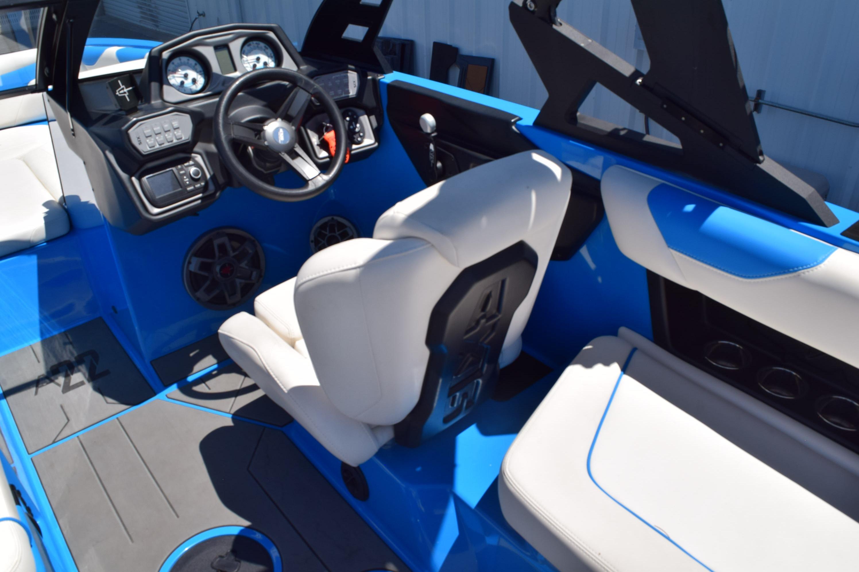 2019 Axis A22 boat interior with blue and white seating, modern dashboard, and steering wheel.