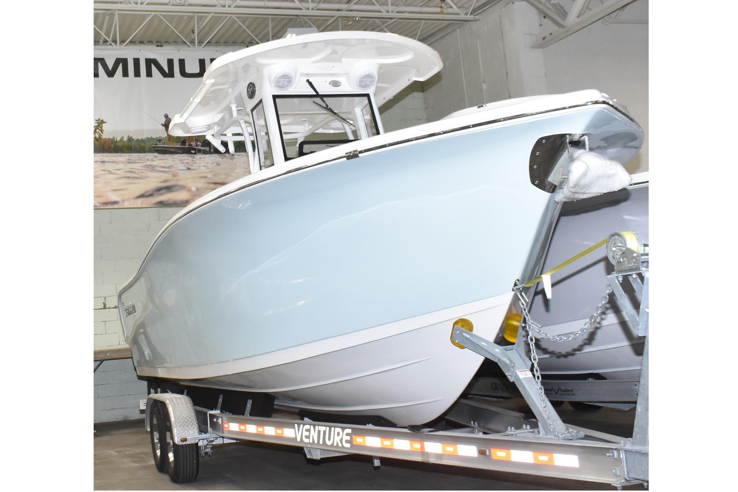 2025 Sea Pro 262 Offshore boat on trailer in indoor showroom.