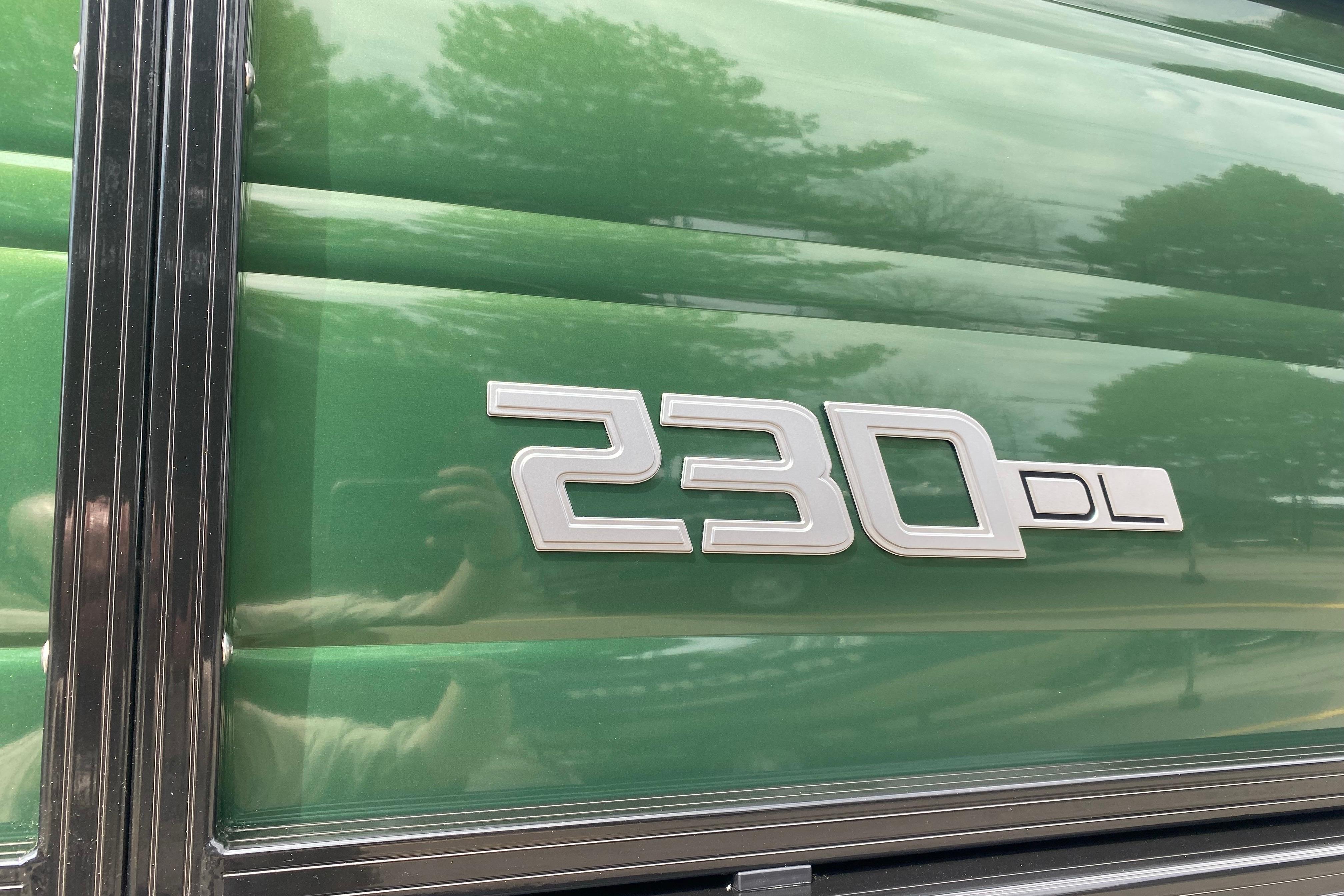 Green Regency 230 DL 2026 model emblem on vehicle exterior.