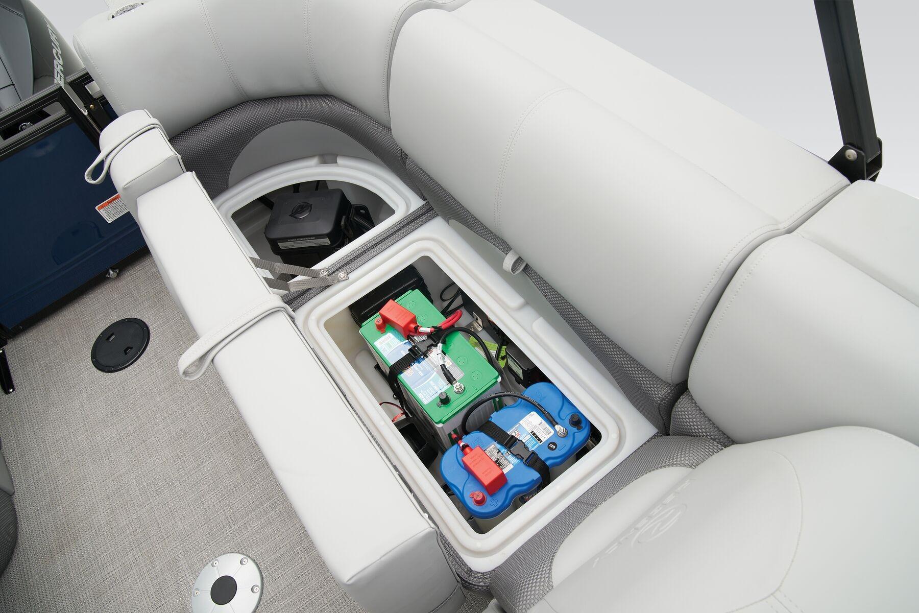 2026 Regency 230 DL boat battery compartment under cushioned seating.