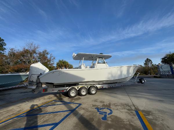 2025 Yellowfin 39 Offshore boat on trailer in parking lot under clear sky.