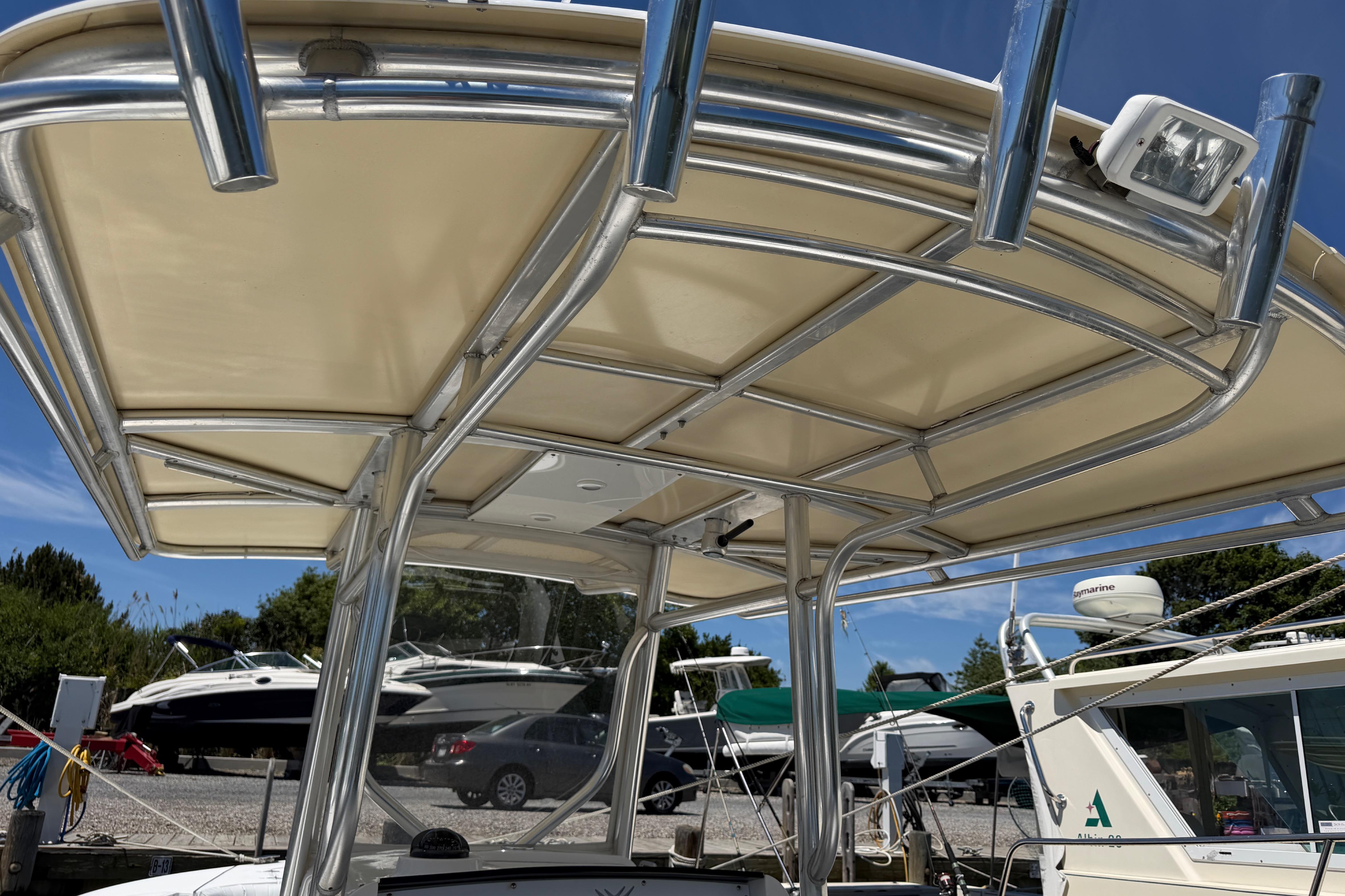 2006 Southport 26 Center Console boat with sturdy T-top and rod holders.