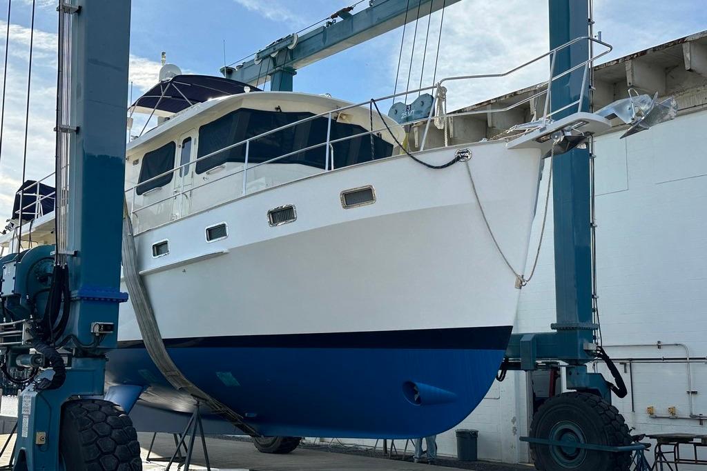 Kadey-Krogen 48 AE 2011 yacht in dry dock, blue and white hull, under maintenance.
