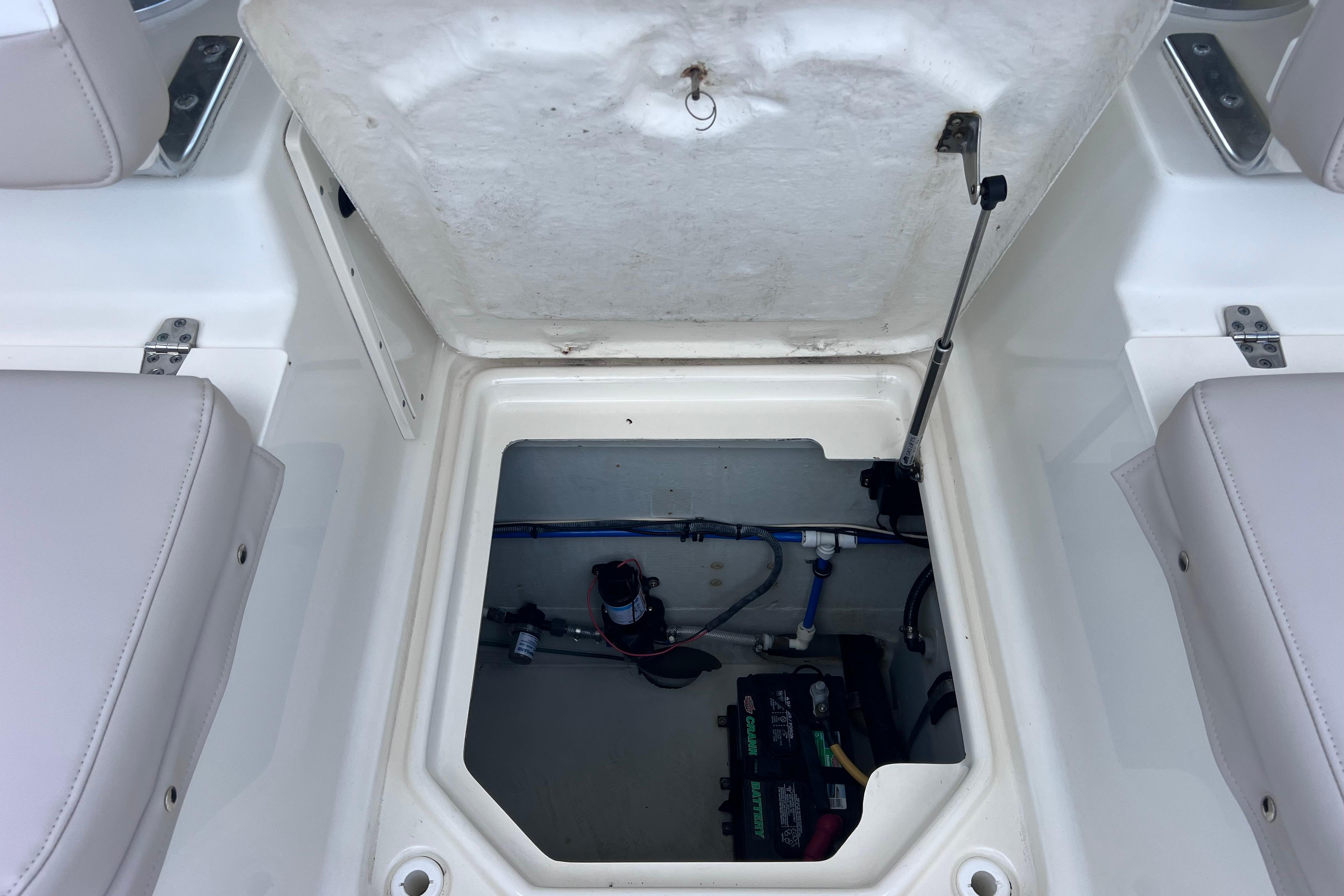 Open hatch of a 2004 Pursuit 2870 Walkaround boat showing internal components.