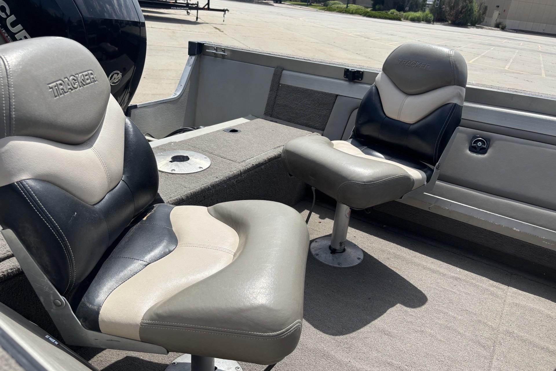 Two cushioned seats on a 1999 Tracker Targa 18 boat interior.