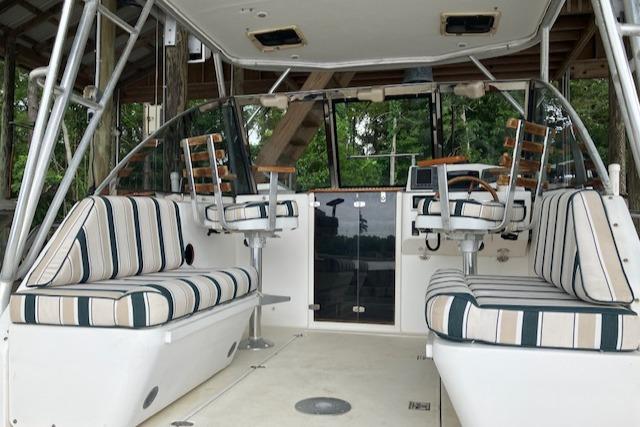 2001 Legacy Boat 28 Express interior with striped seating and helm chairs.