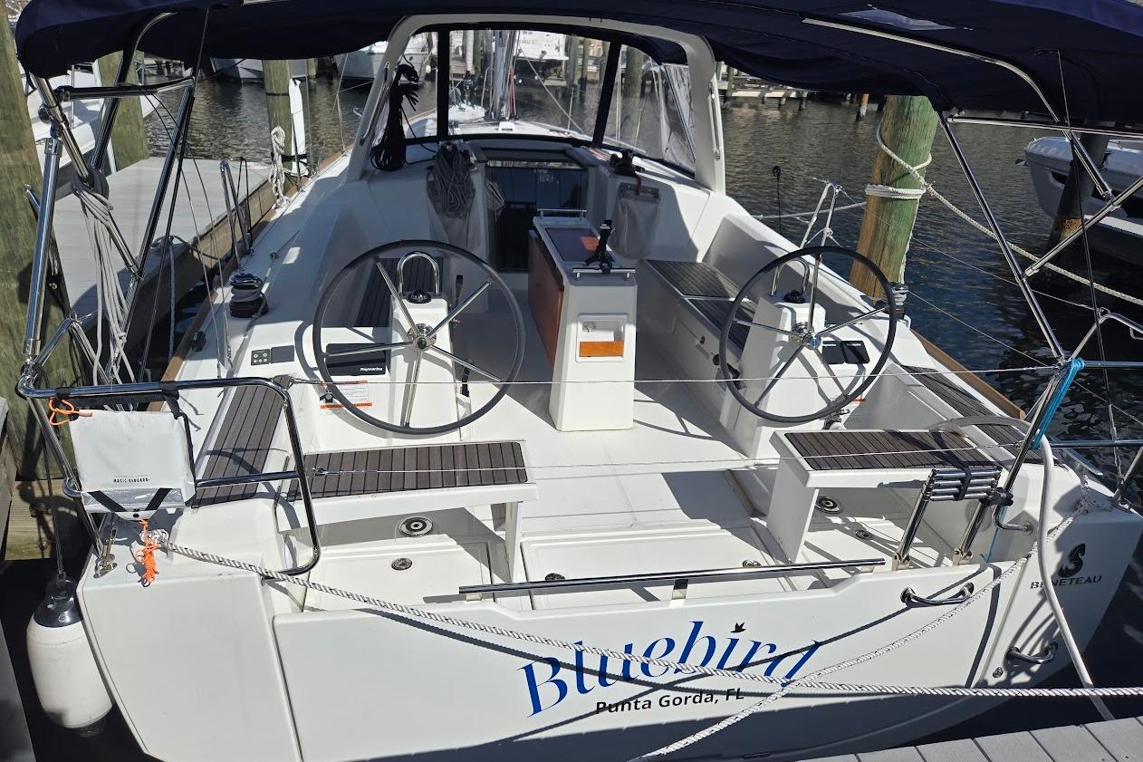 2023 Beneteau Oceanis 38.1 sailboat docked, featuring dual steering wheels and spacious cockpit.