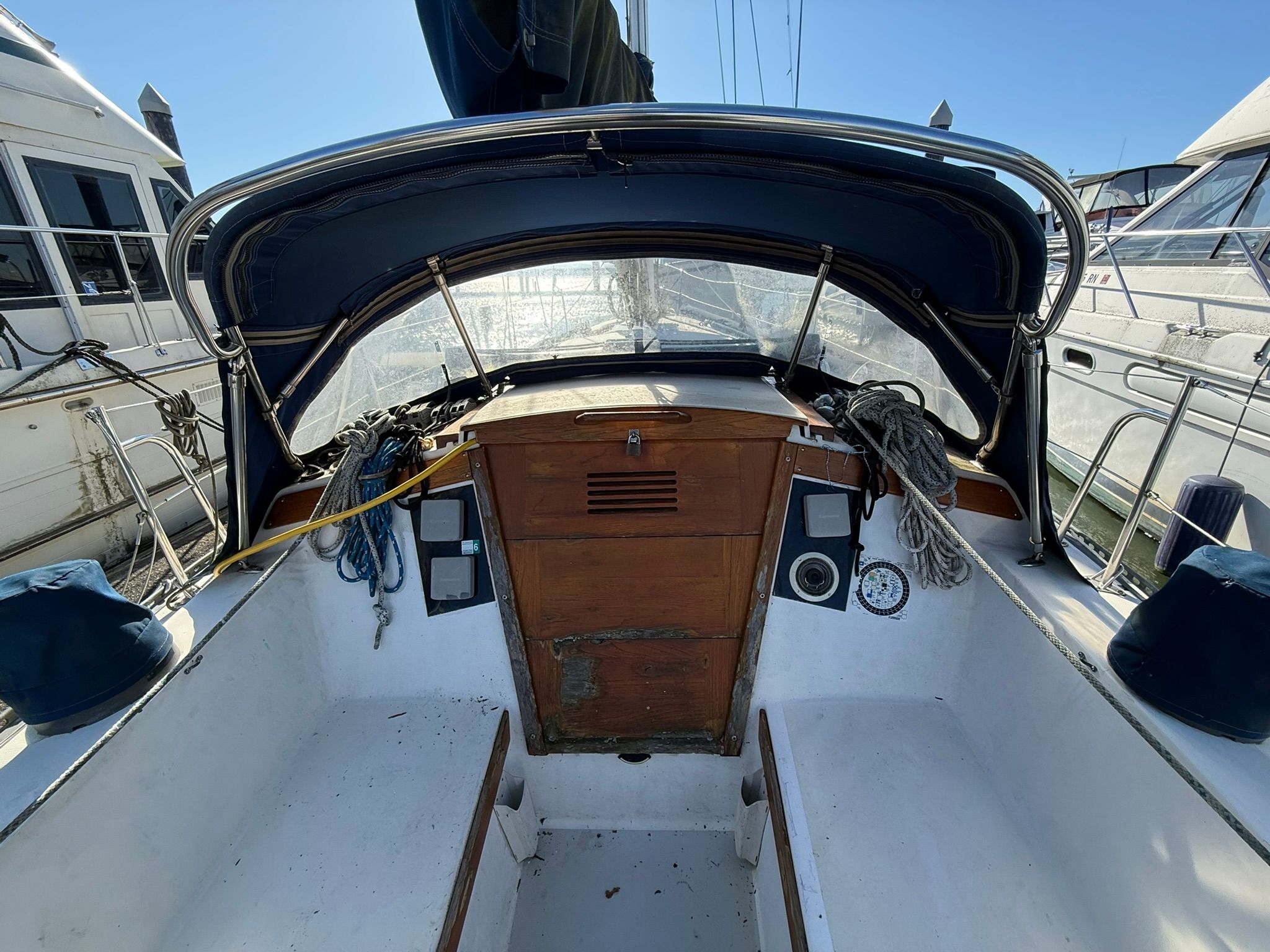 Cockpit of a 1980 Catalina 38 sailboat docked at marina.