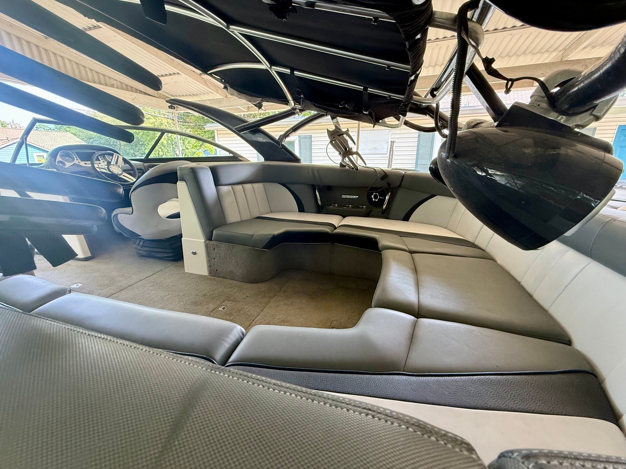 Interior of a 2012 Supra Launch 242 with gray and white seating.