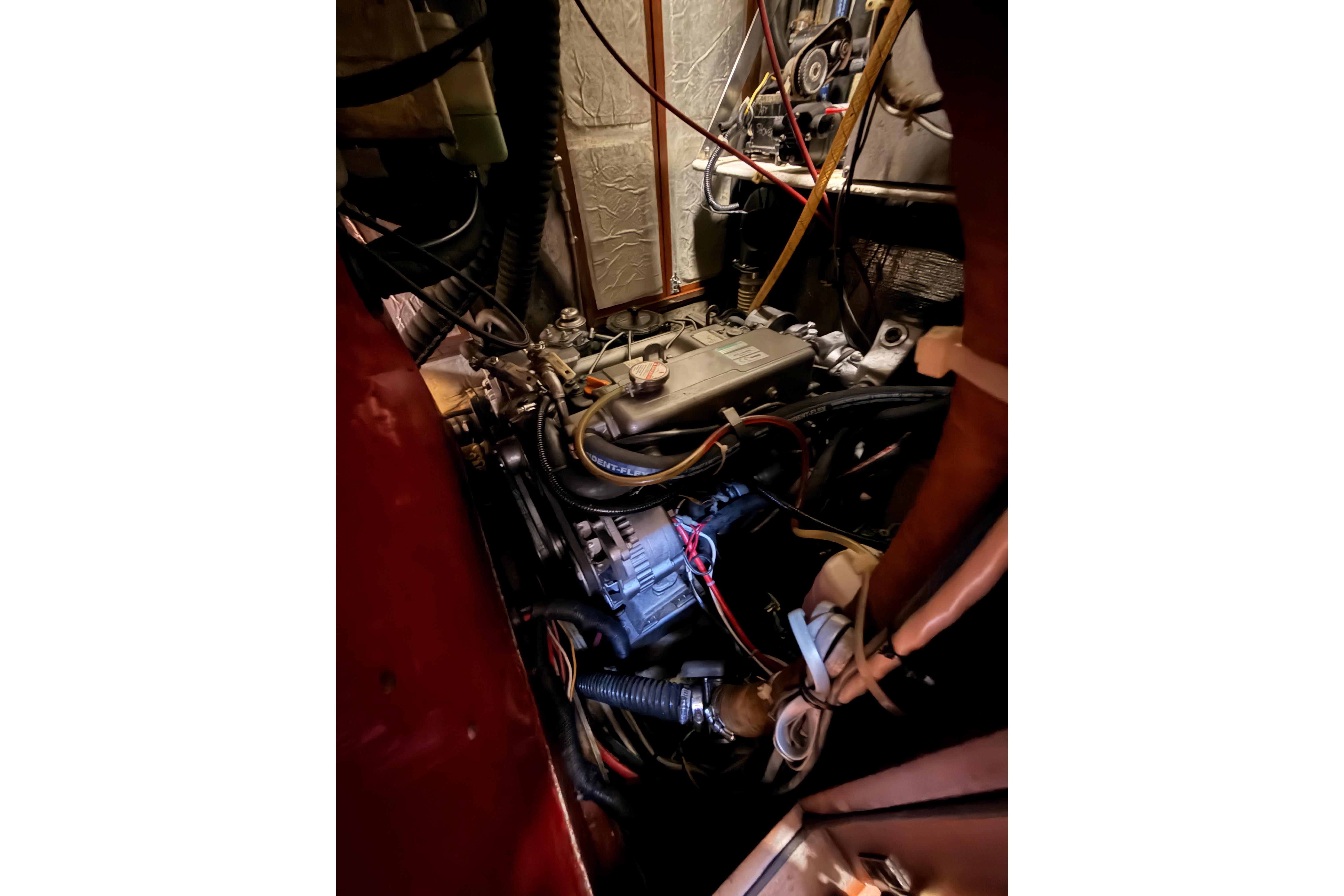 Engine compartment of a 1991 Hylas 51 sailboat, showcasing wiring and mechanical components.
