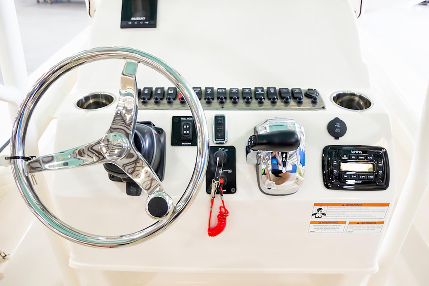 Manufacturer Provided Image: Control panel of 2026 Carolina Skiff 26 Ultra Elite boat with steering wheel and switches.