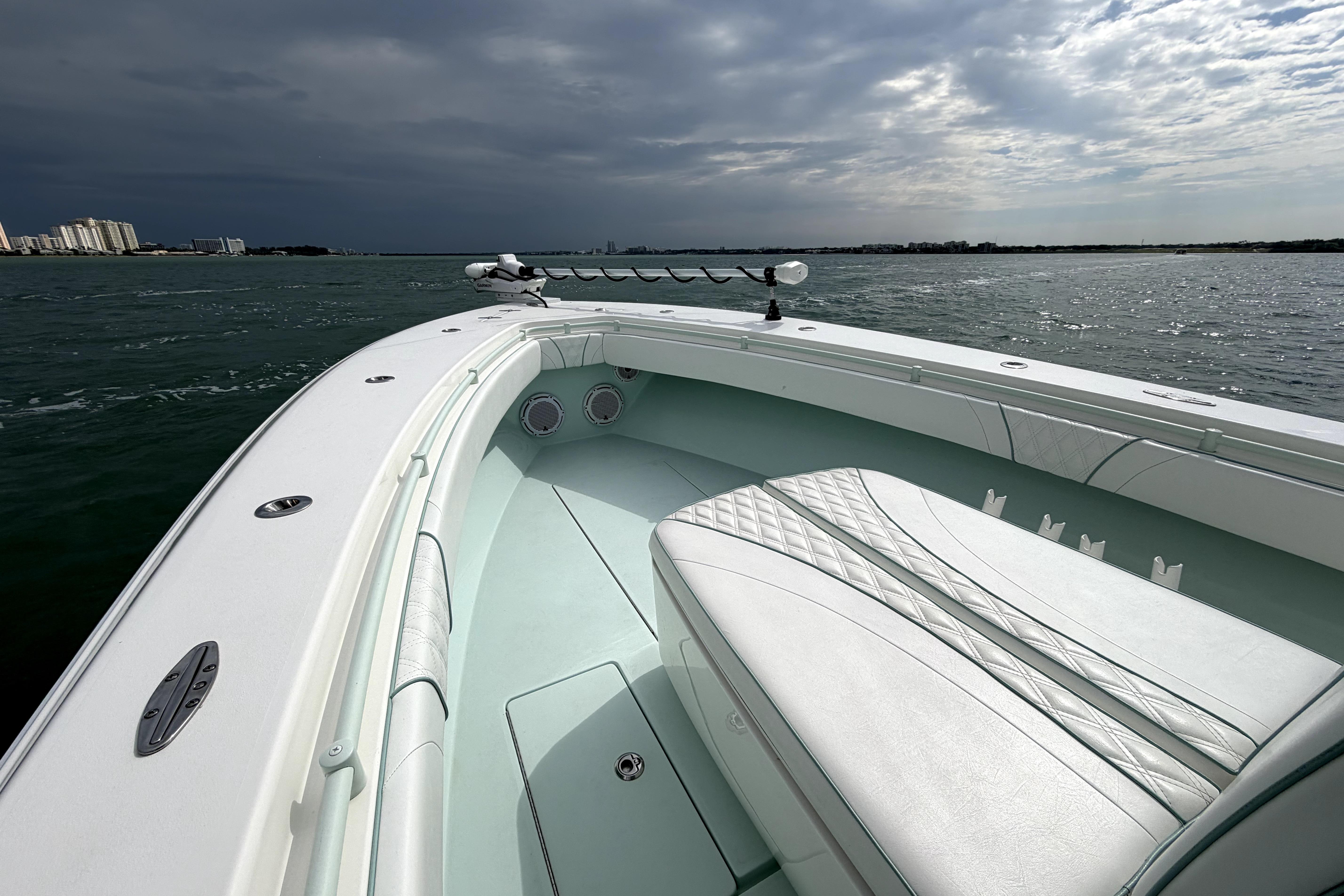 2019 Contender 30 ST boat on water, featuring sleek white interior and overcast sky.