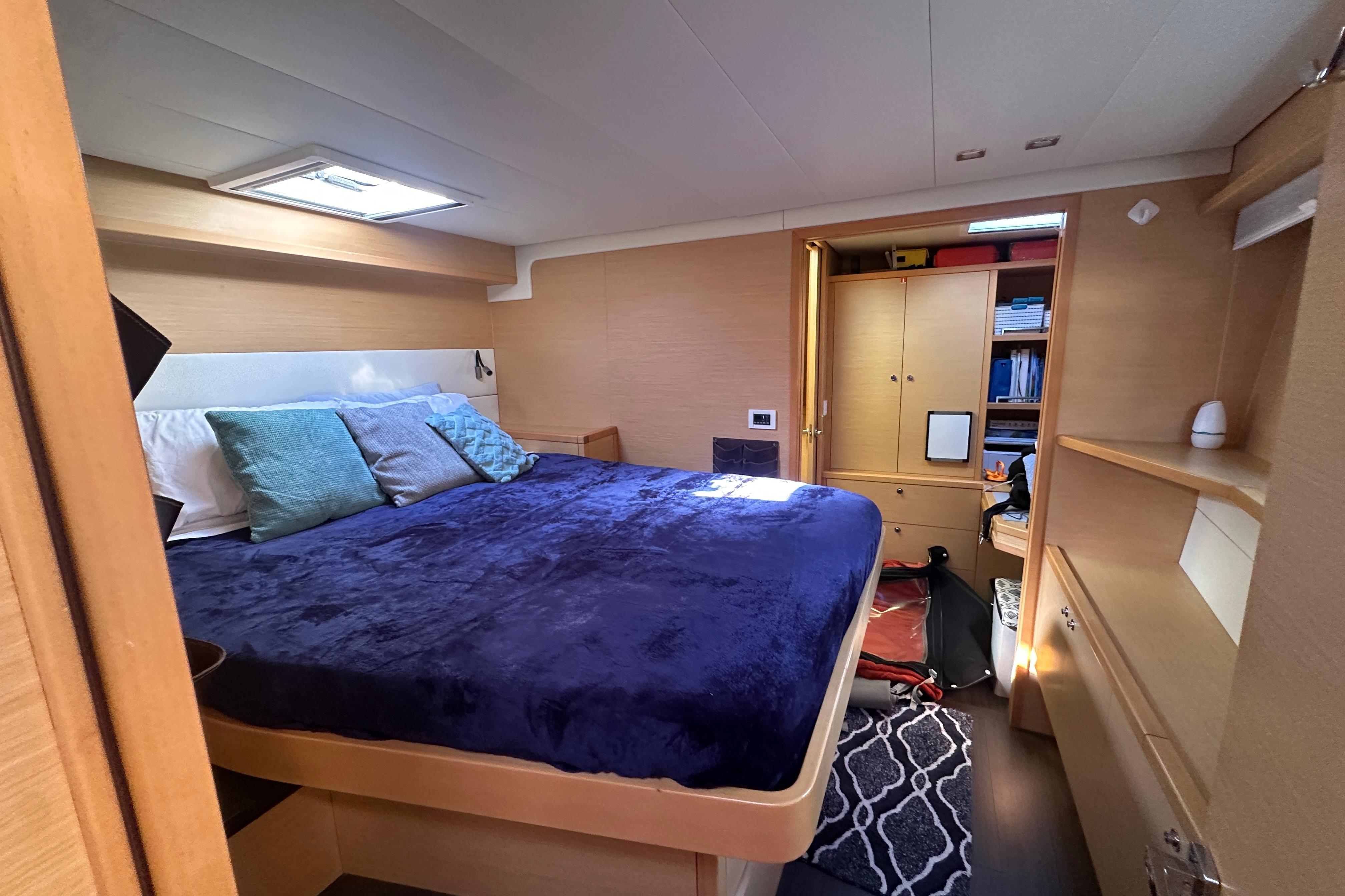 Luxurious cabin interior of 2017 Lagoon 52 F yacht with cozy bedding and ample storage.