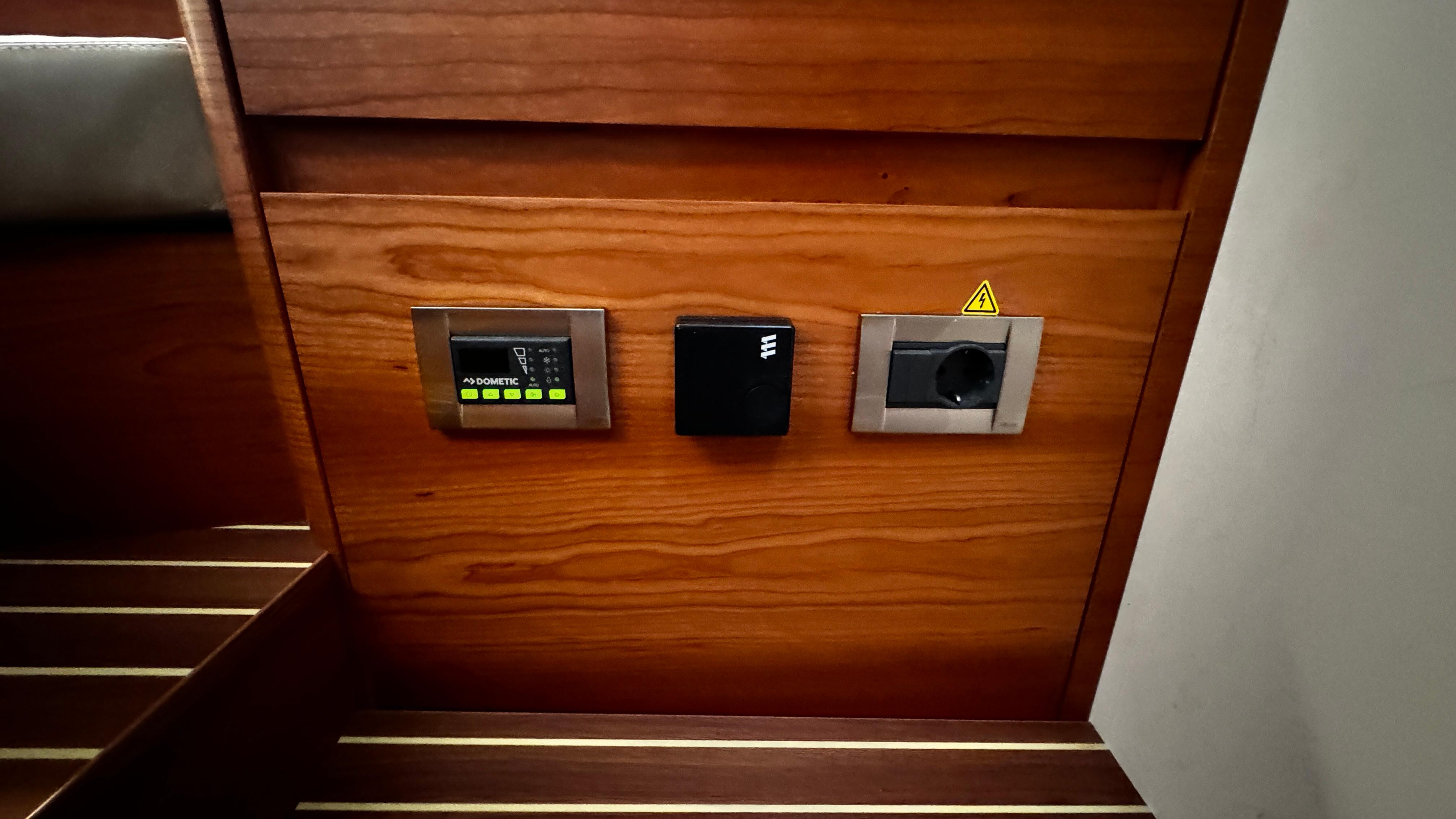 Control panel on 2020 Hanse 588 yacht with wooden finish.