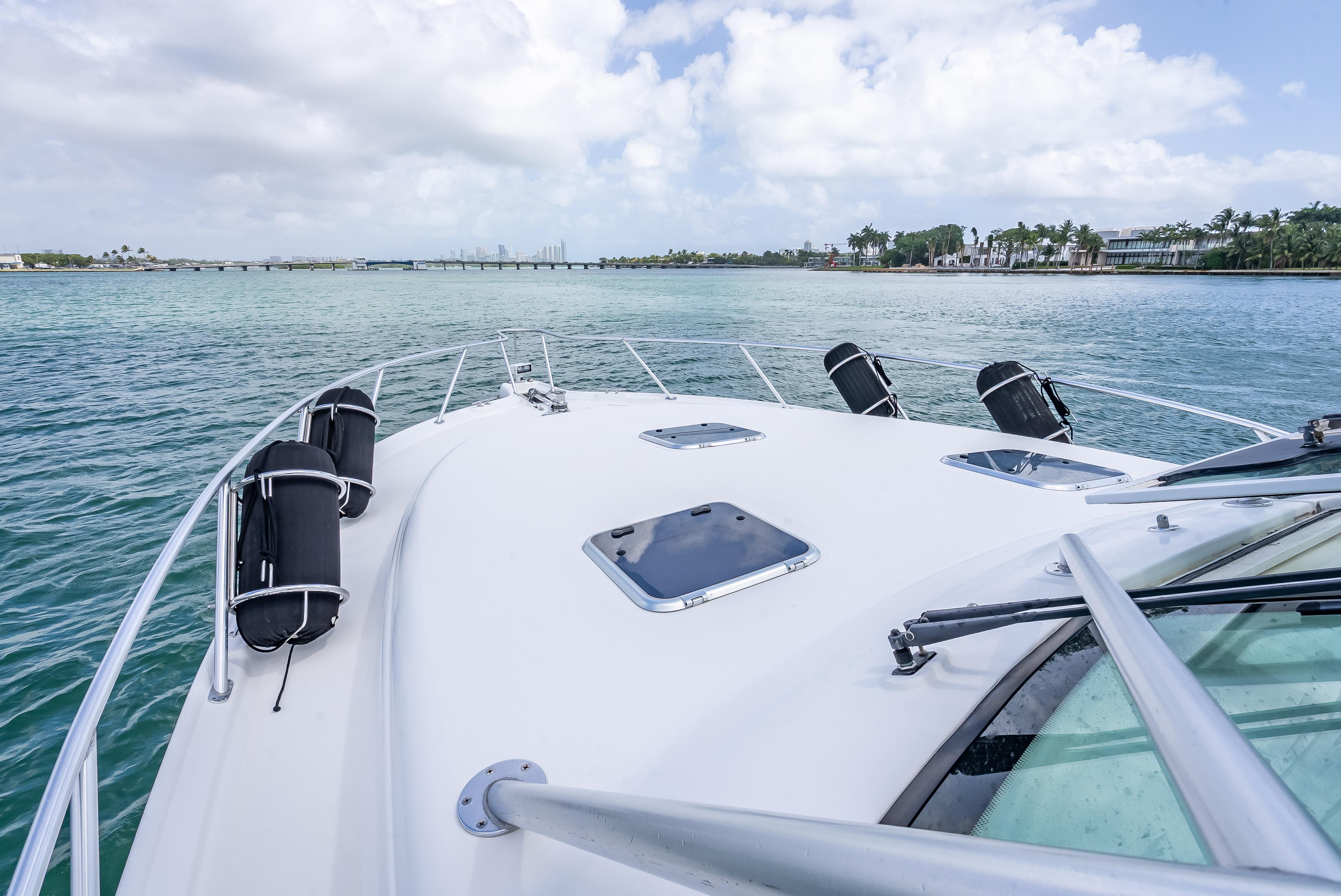 2006 Tiara Yachts 4200 Open cruising on calm waters under a cloudy sky.