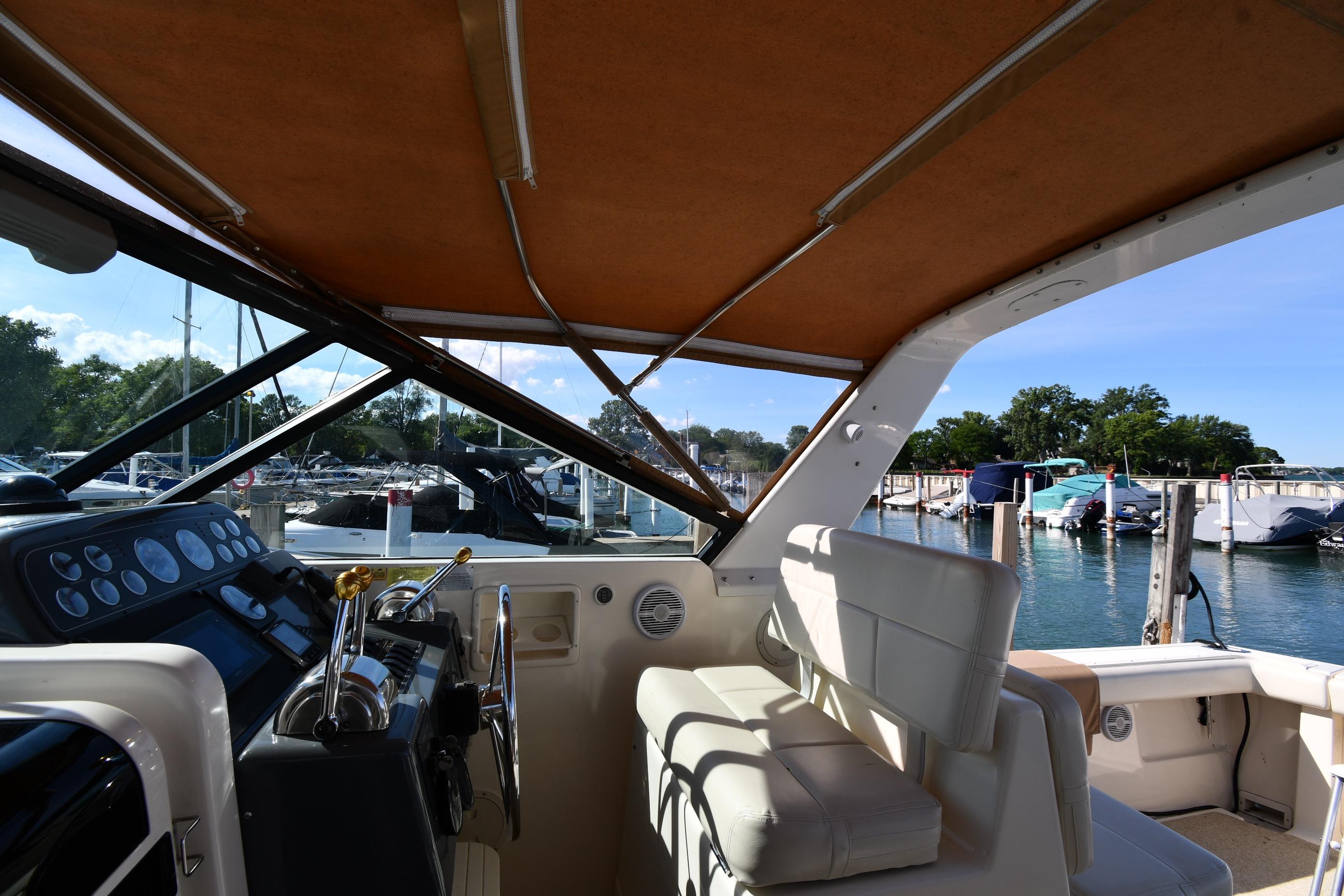 1998 Tiara Yachts 3100 Open interior with helm, docked at marina.