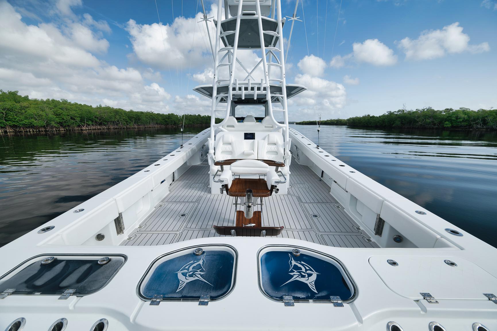 Luxury Freeman 47 boat interior, 2022 model, featuring spacious deck and fishing amenities on calm waters.