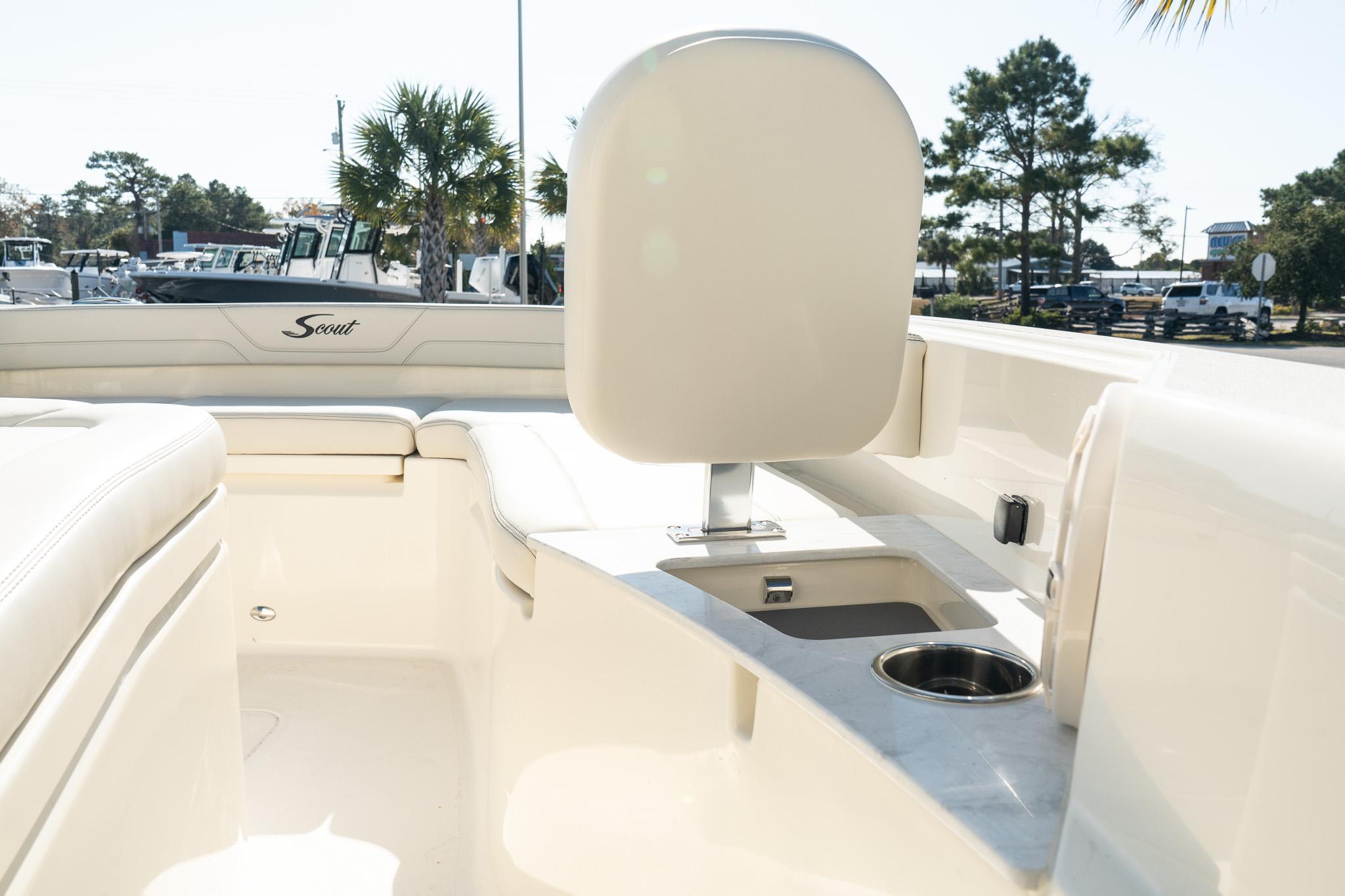 2025 Scout 261 XSS boat interior with seating and cup holder, outdoor setting.