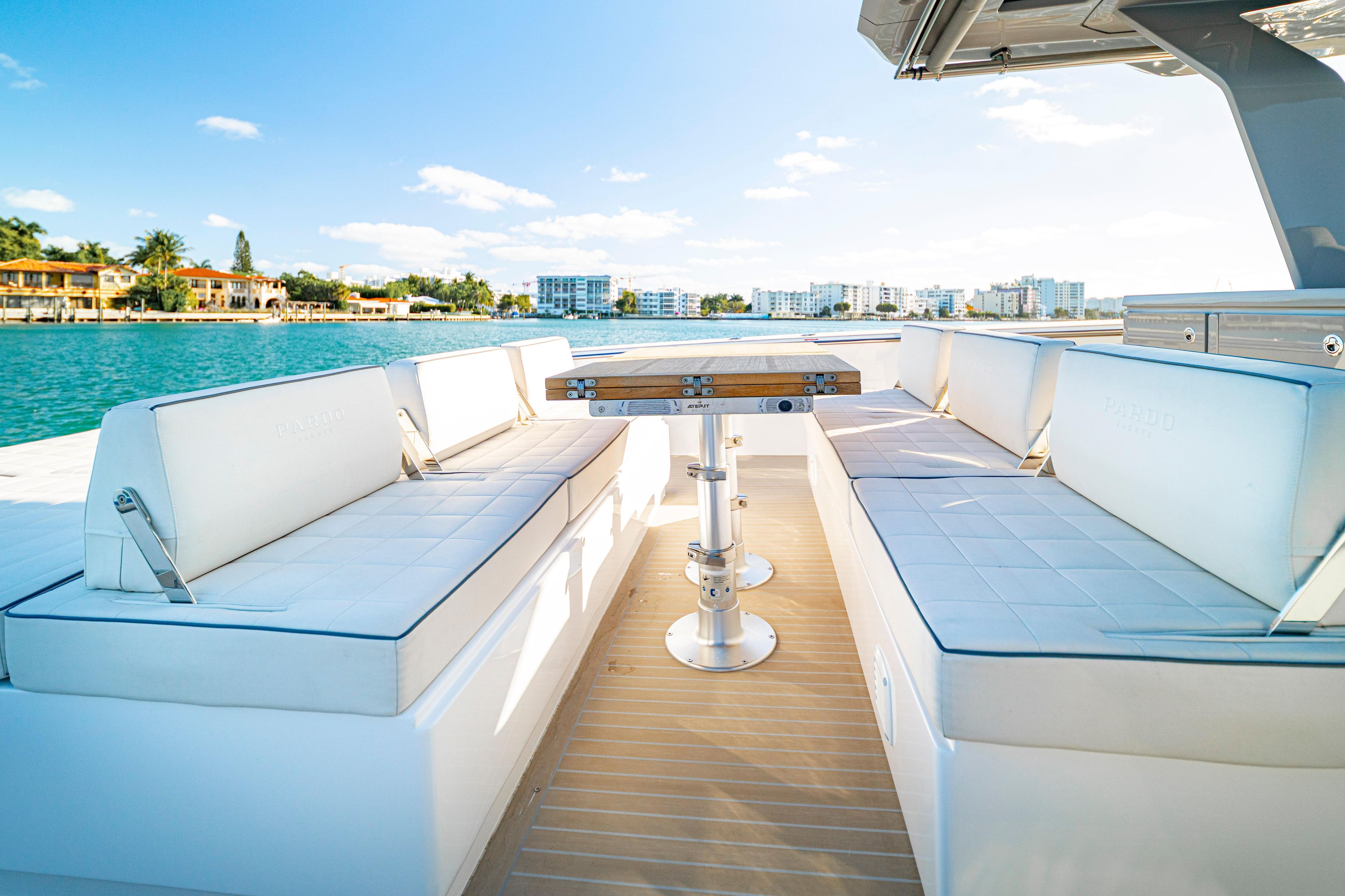 Luxurious seating area on 2024 Pardo Yachts P43, with scenic waterfront view.
