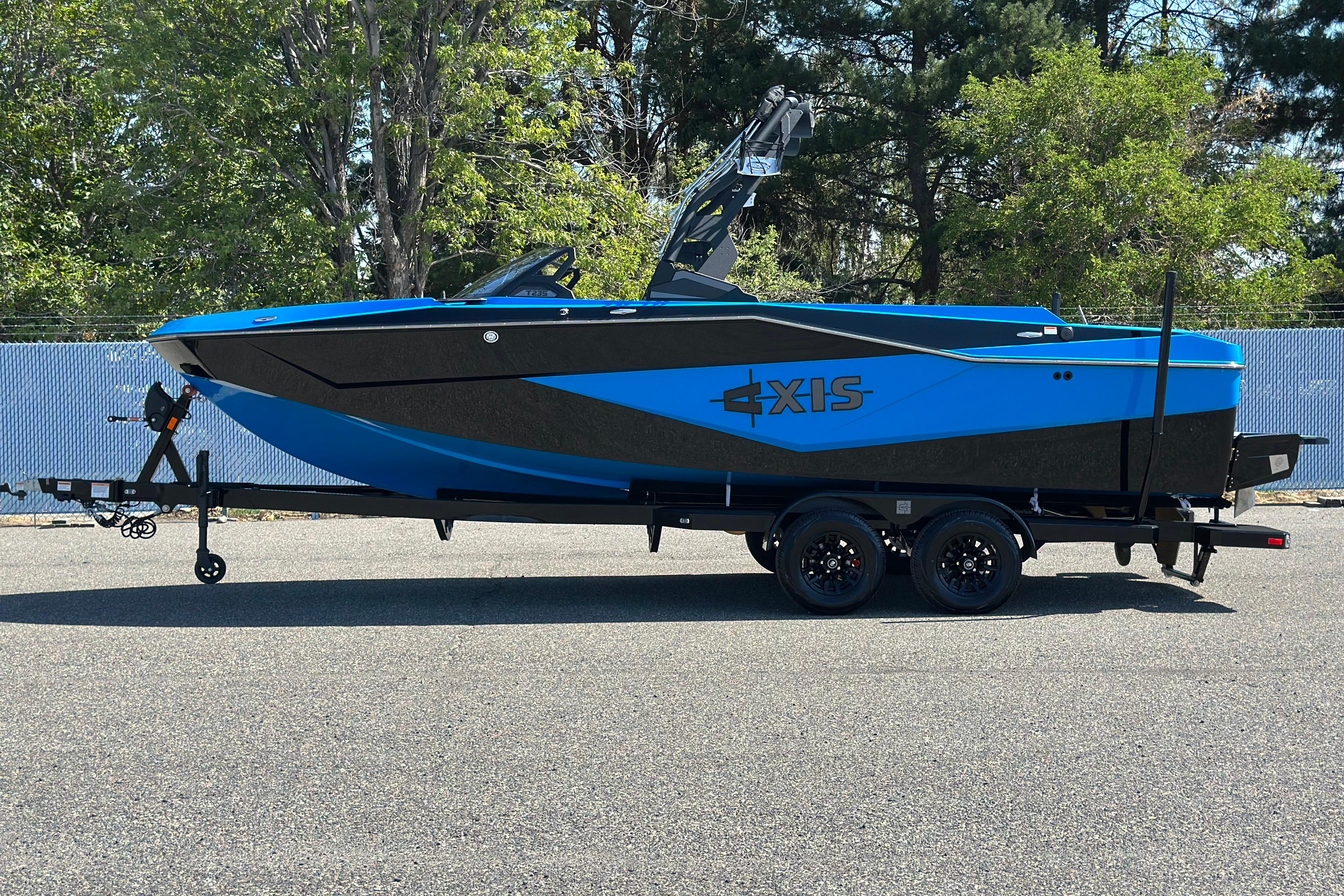 2026 Axis T235 boat on trailer, blue and black design, parked outdoors.