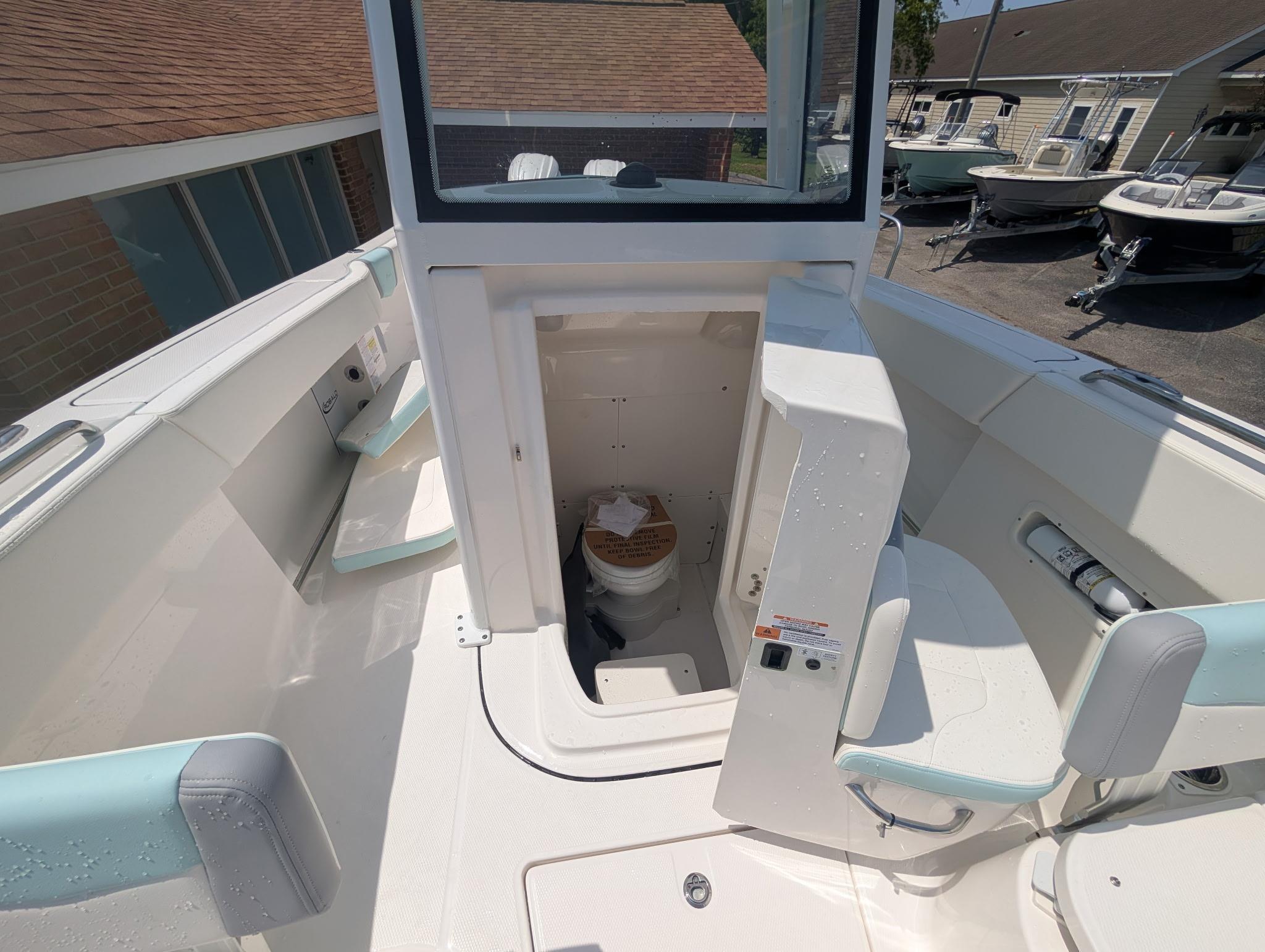 2025 Robalo R250 Center Console boat interior with open console door and seating.