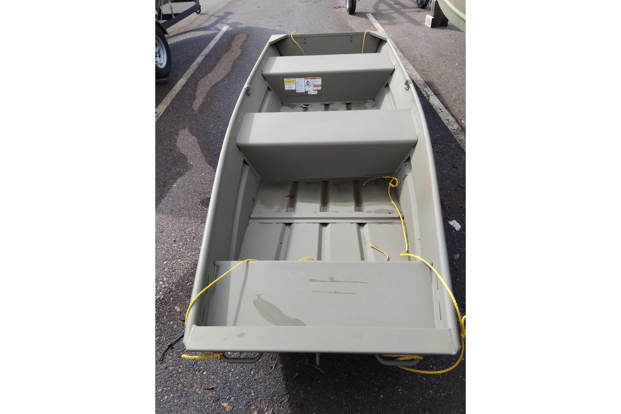 2026 Tracker Grizzly 12 Jon boat, parked on pavement, featuring a simple, sturdy design.
