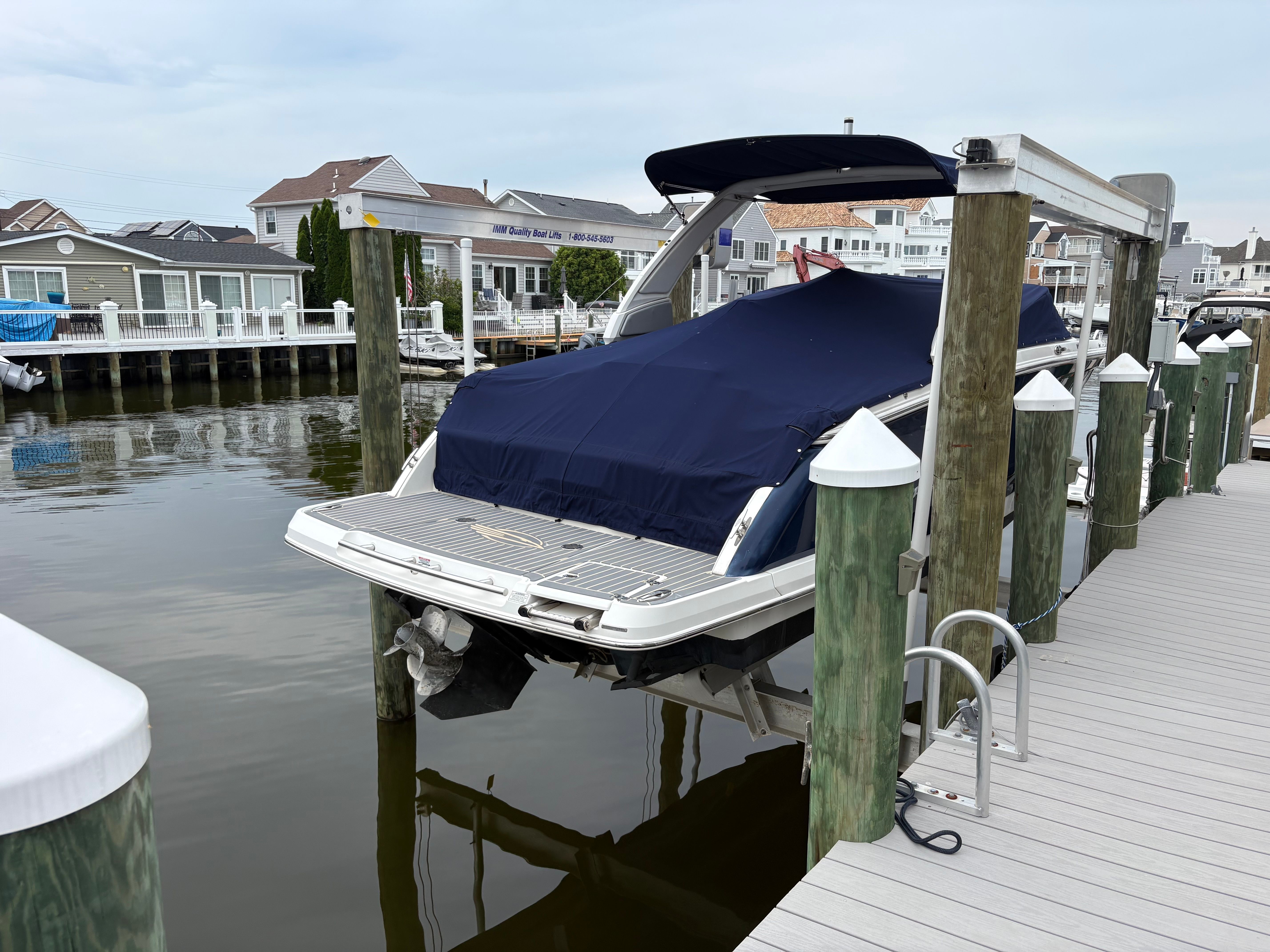 A 2019 Chaparral SSX277 is docked, covered with a blue tarp.