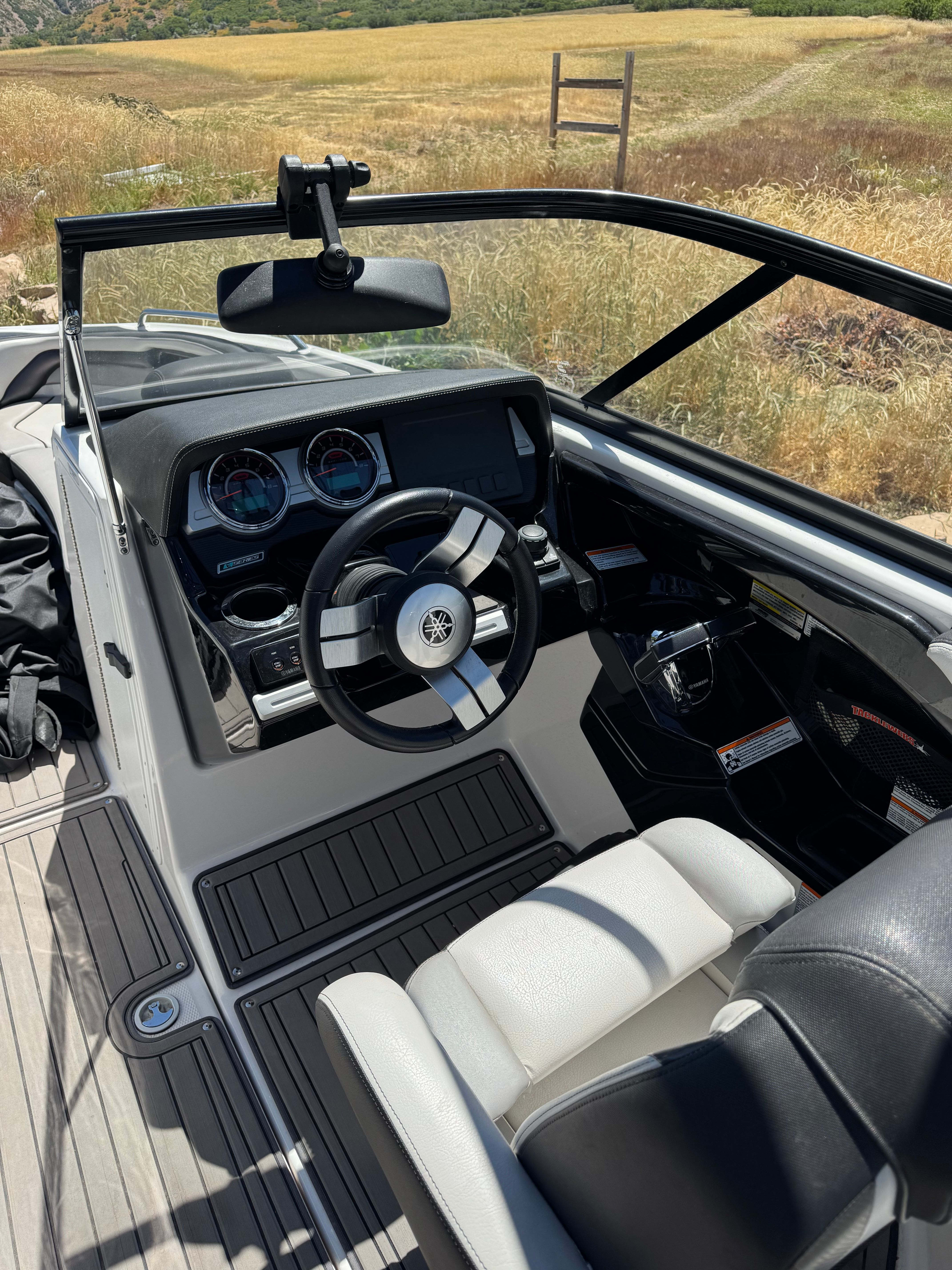 The image shows the cockpit of a 2017 Yamaha 242X E-Series boat with modern instruments.