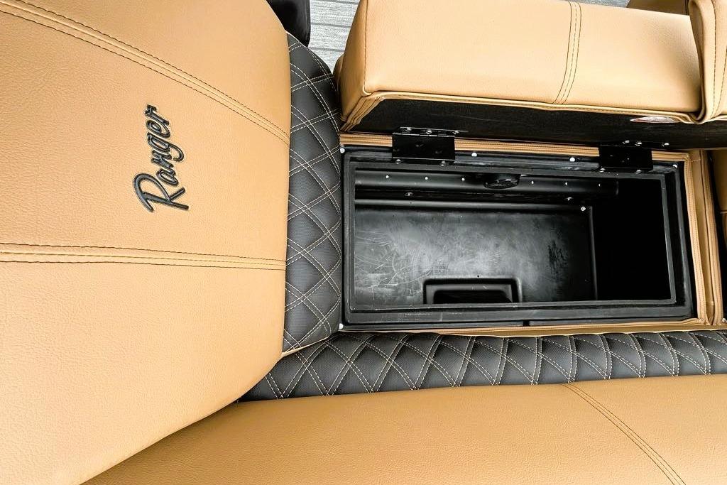 Tan and black Ranger 220FC 2026 boat seat with storage compartment open.