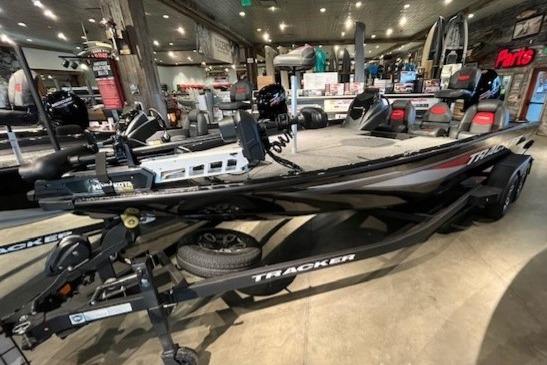 2025 Tracker Savage 215 boat displayed in a showroom with modern features.