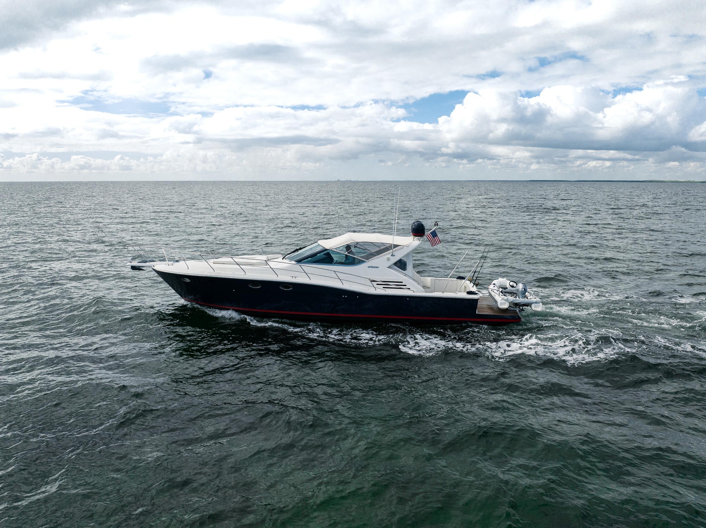 2001 Uniesse 48 Open yacht cruising on open sea under cloudy sky.