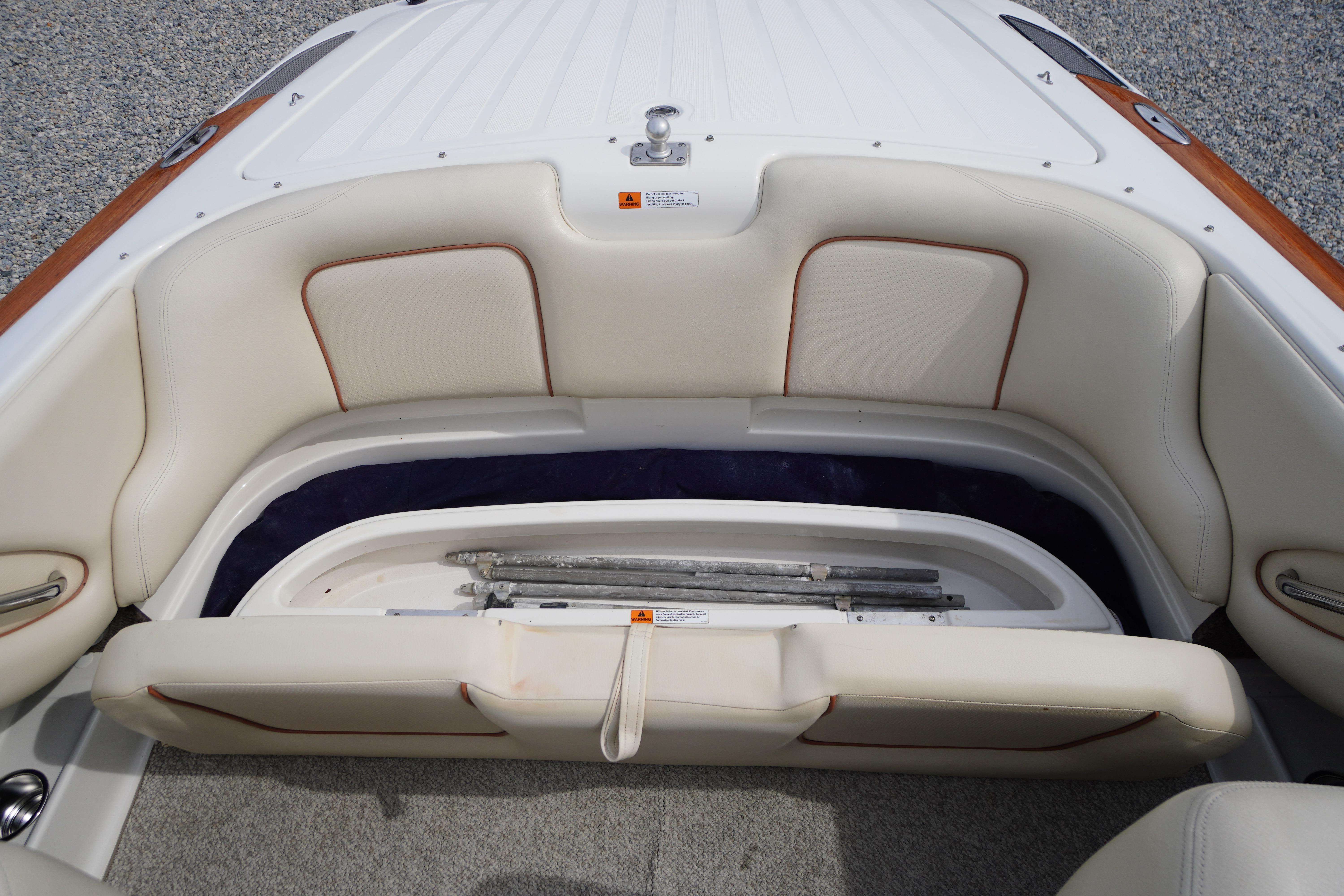 2005 Chris Craft Speedster Heritage boat interior with white leather seating and storage compartment.