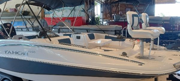 2024 Tahoe 1950 boat in showroom, featuring sleek design and comfortable seating.