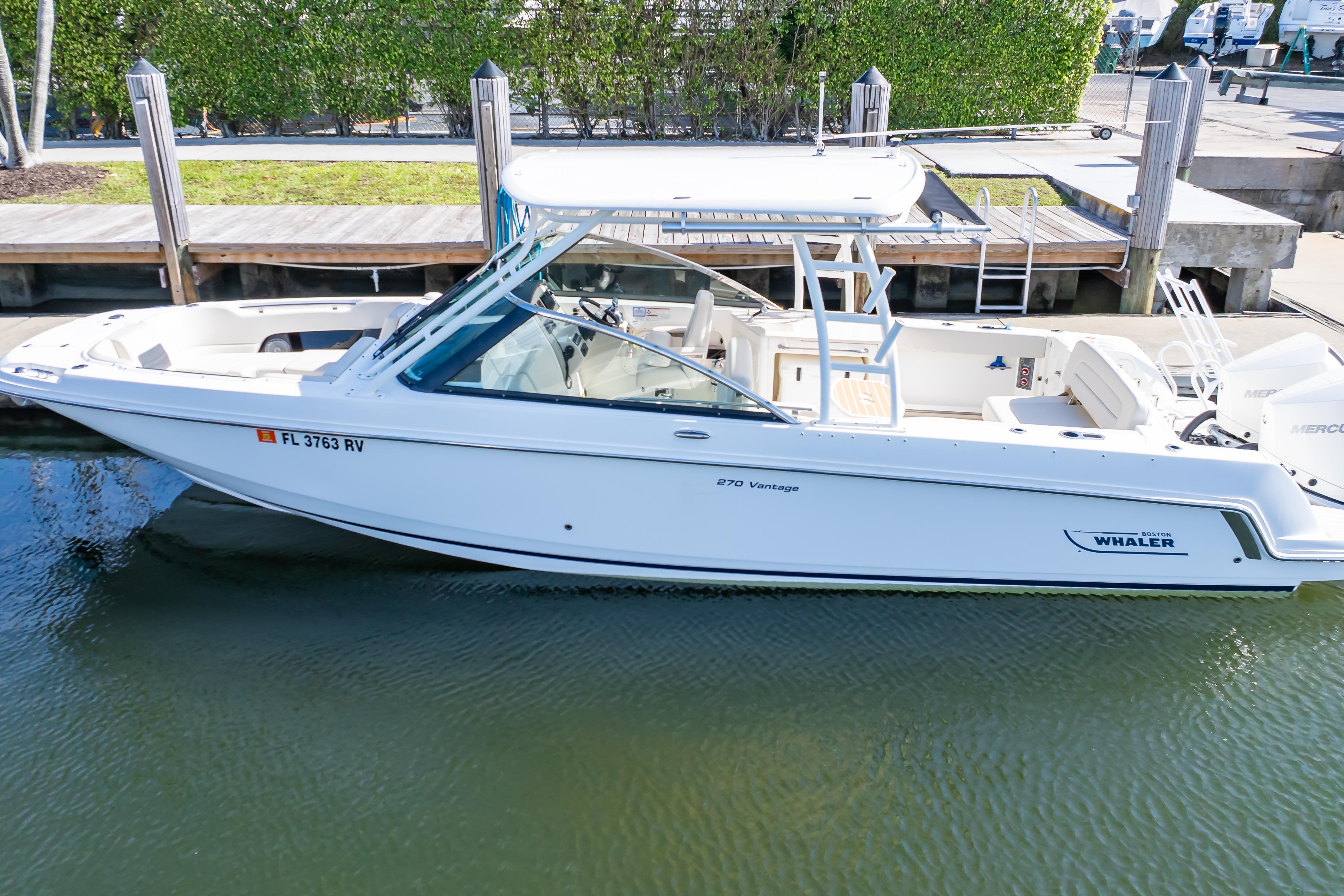 2019 Boston Whaler 270 Vantage boat docked in calm waters.