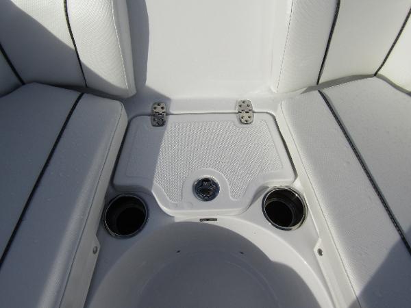 2025 Wellcraft 243 Fisherman boat seating area with cup holders and storage.