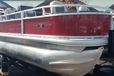 2026 Sun Tracker Bass Buggy 18 DLX pontoon boat with red exterior and silver pontoons.