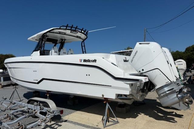 2026 Wellcraft 38 T-Top boat with dual engines on display outdoors.