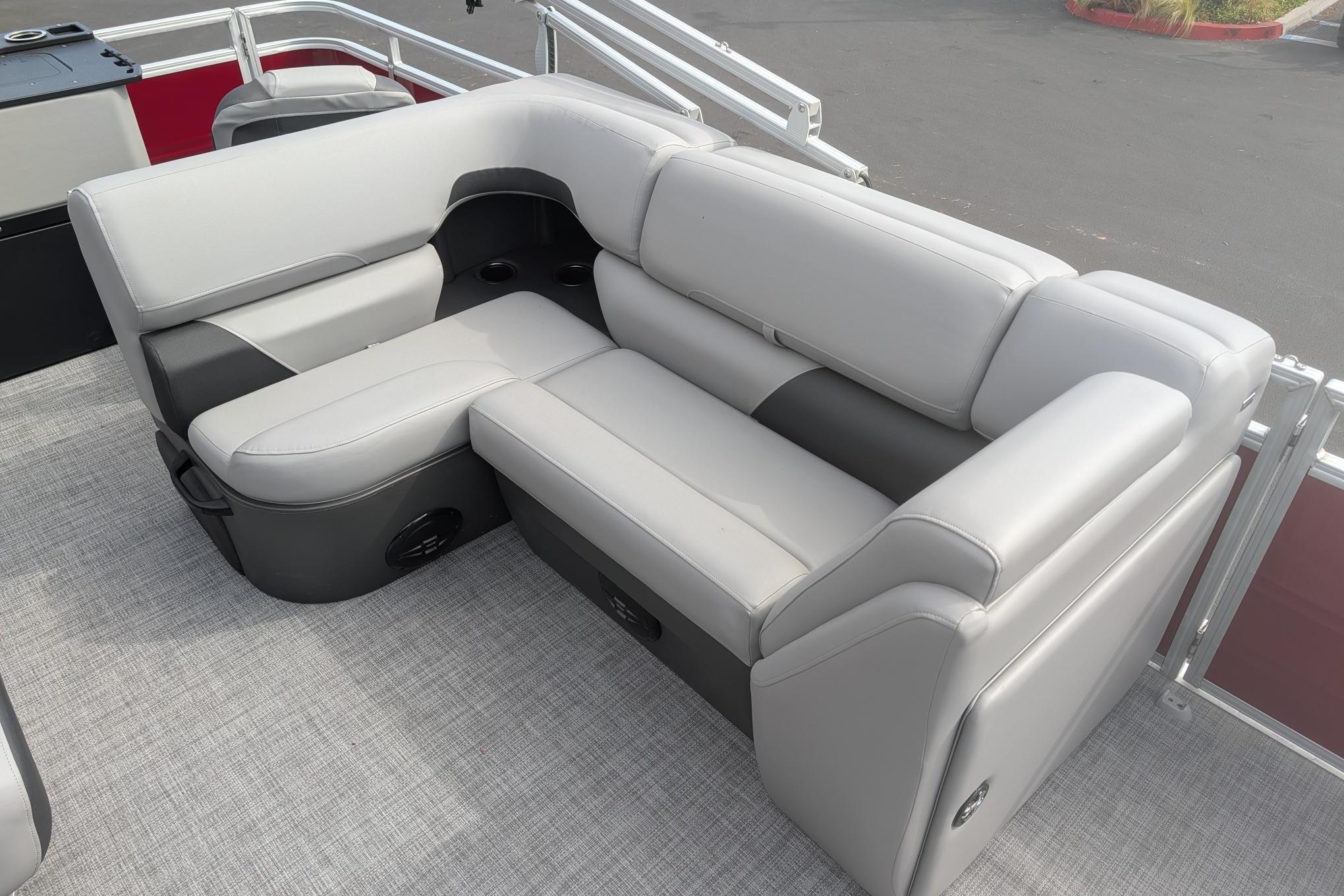 2026 Sun Tracker SportFish 20 DLX pontoon boat seating, featuring plush gray upholstery.