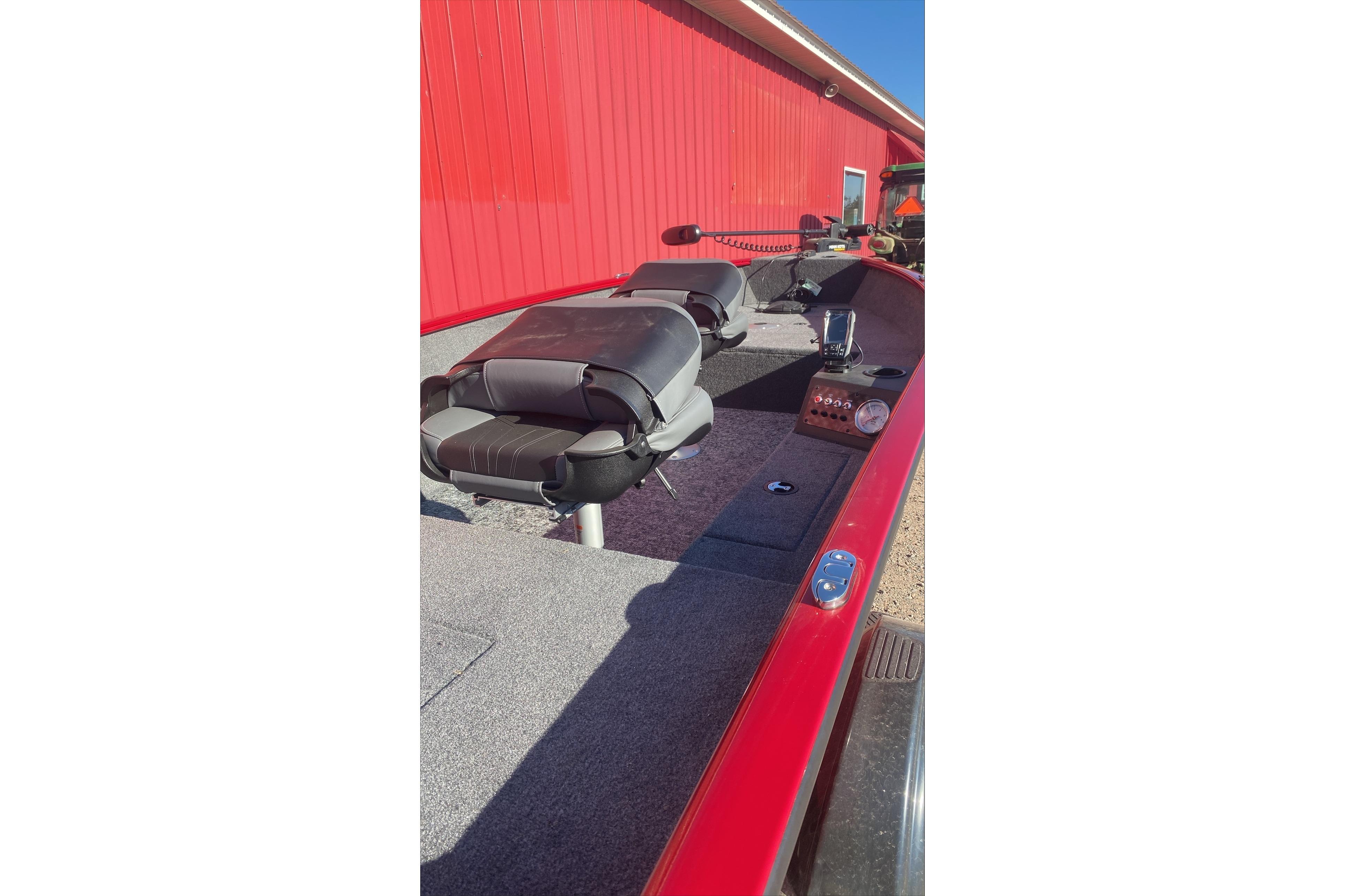2025 Tracker Super Guide V-16 T boat interior with red exterior and seating.