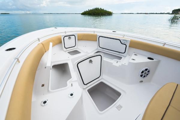 Manufacturer Provided Image: 2025 Sportsman Heritage 231 Center Console boat with open storage compartments on calm water.