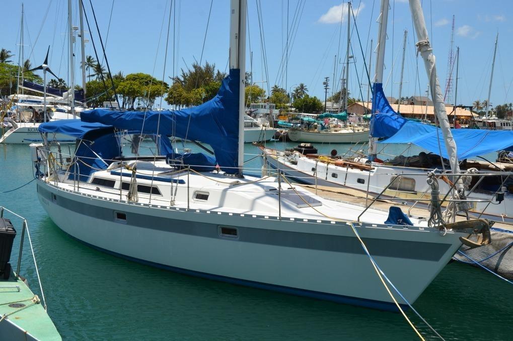 1987 Norseman 400 sailboat docked in a marina.