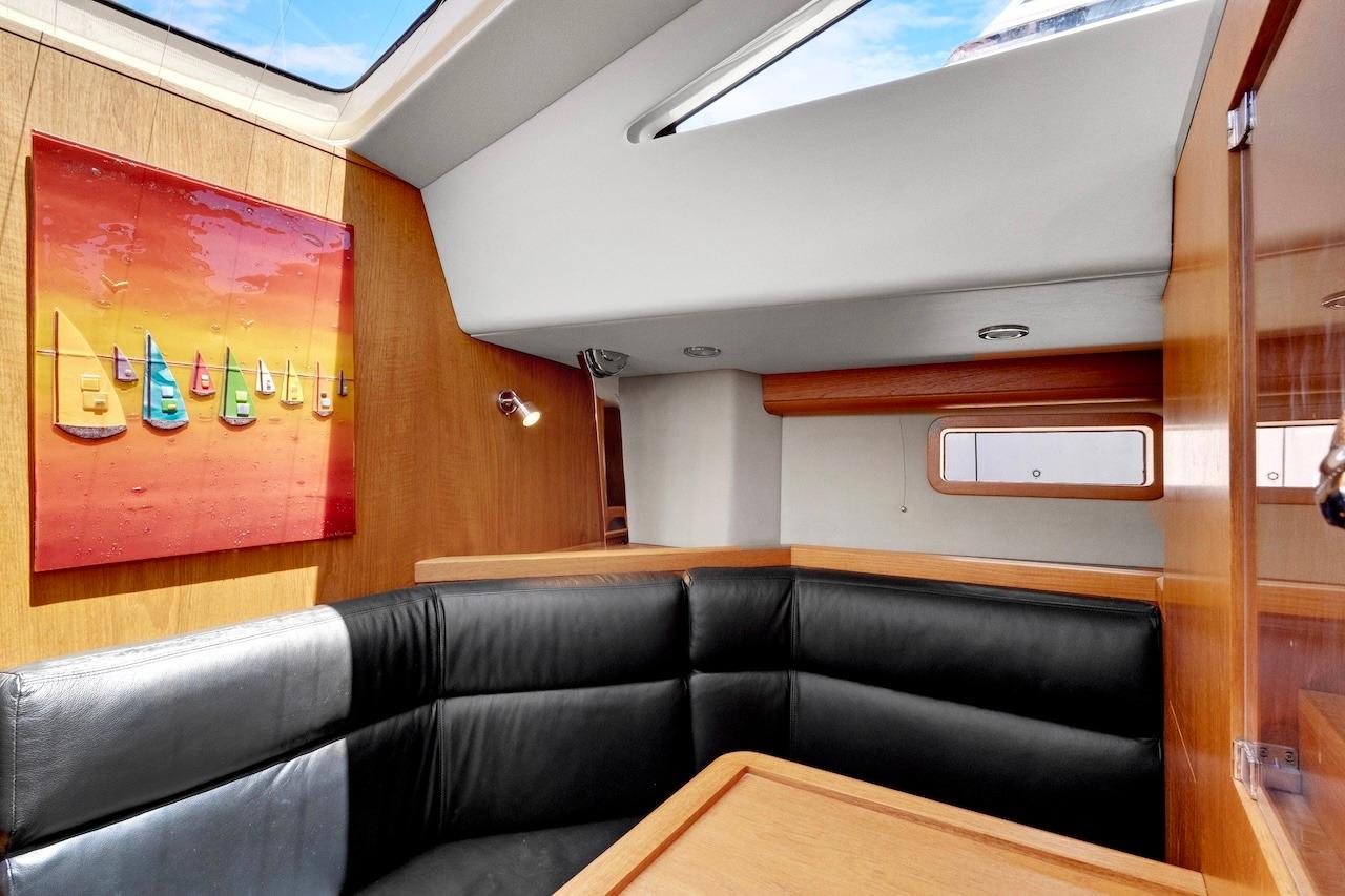 Luxurious interior of 2011 Southerly 57 RS yacht with modern decor and leather seating.