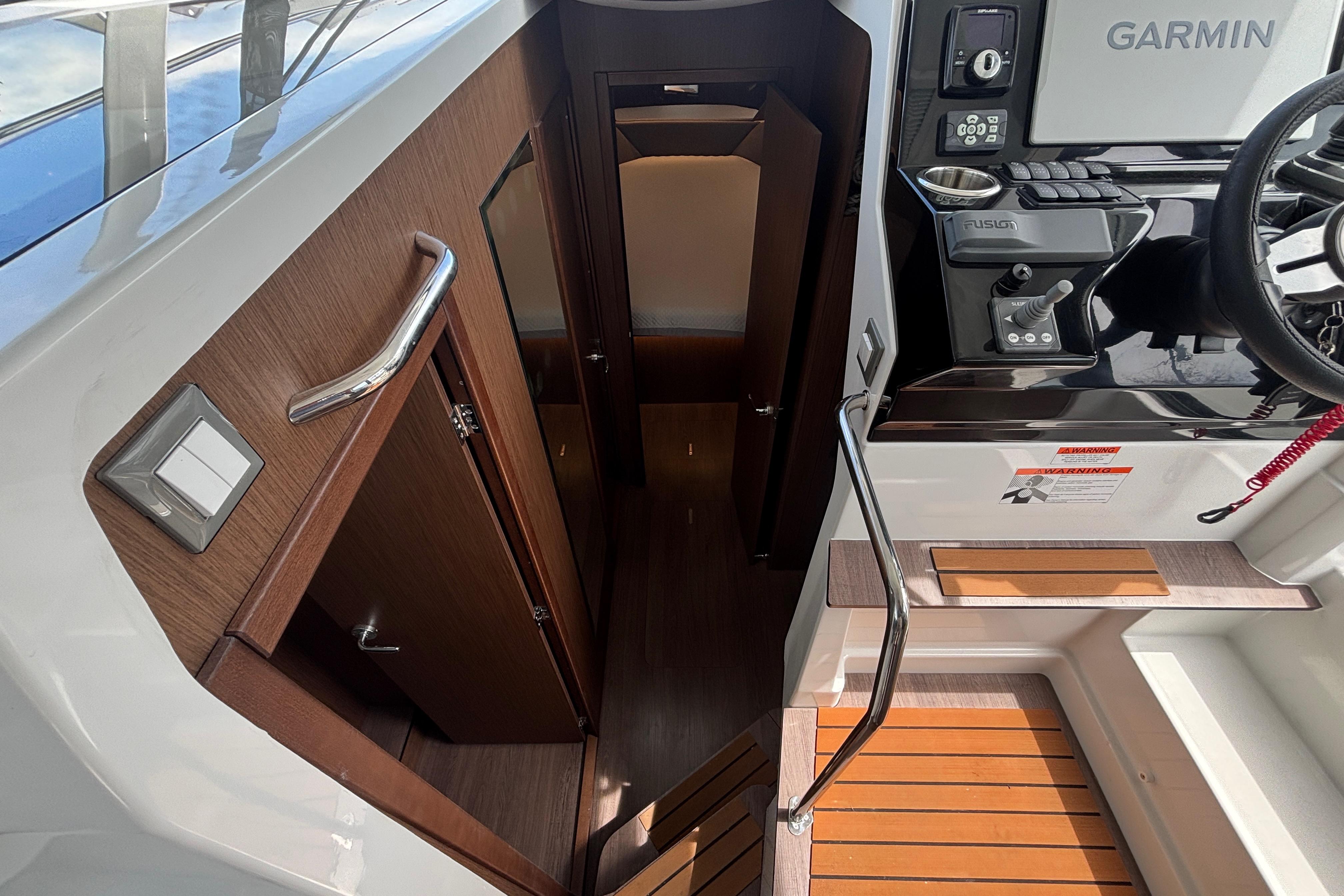 2024 Beneteau Antares 11 interior with wood finish and modern helm controls.