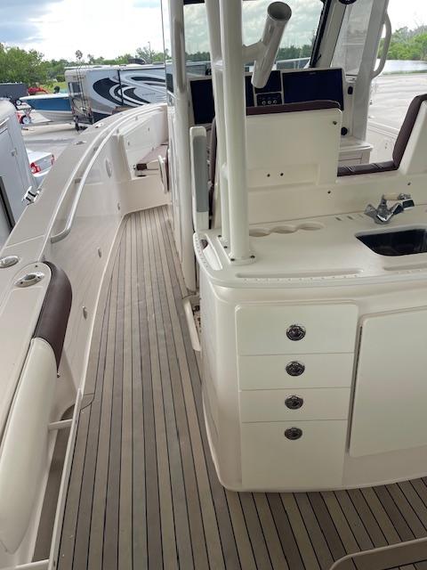 2014 Everglades 325 Center Console boat interior with seating and storage compartments.
