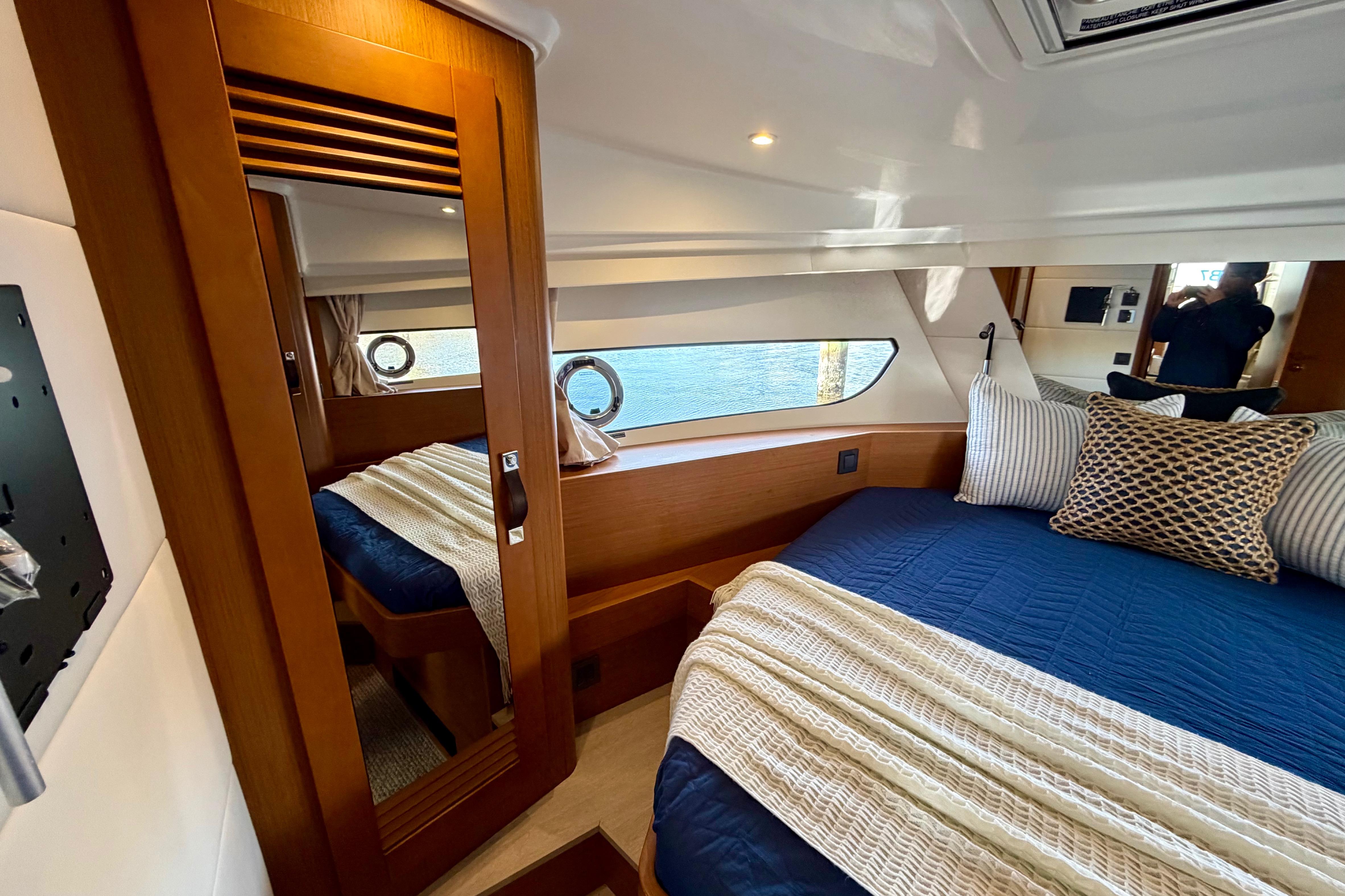 Luxurious cabin interior of 2026 Beneteau Swift Trawler 37 Fly with elegant bedding.