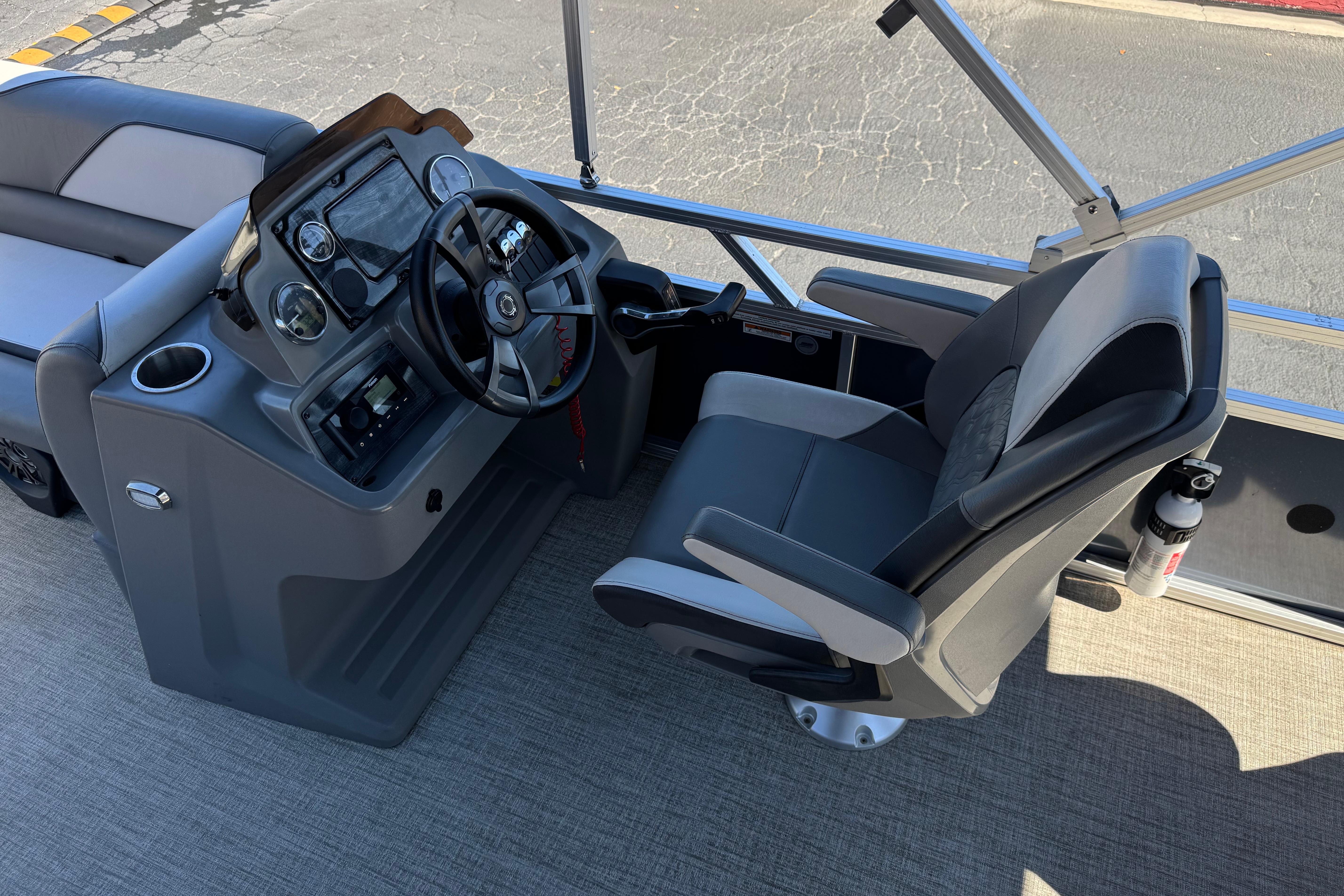 2023 Avalon Venture Fish N Cruise boat interior with steering console and captain's chair.