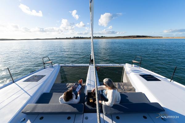 2025 Nautitech 48 Open catamaran on serene water, featuring spacious deck and scenic views.
