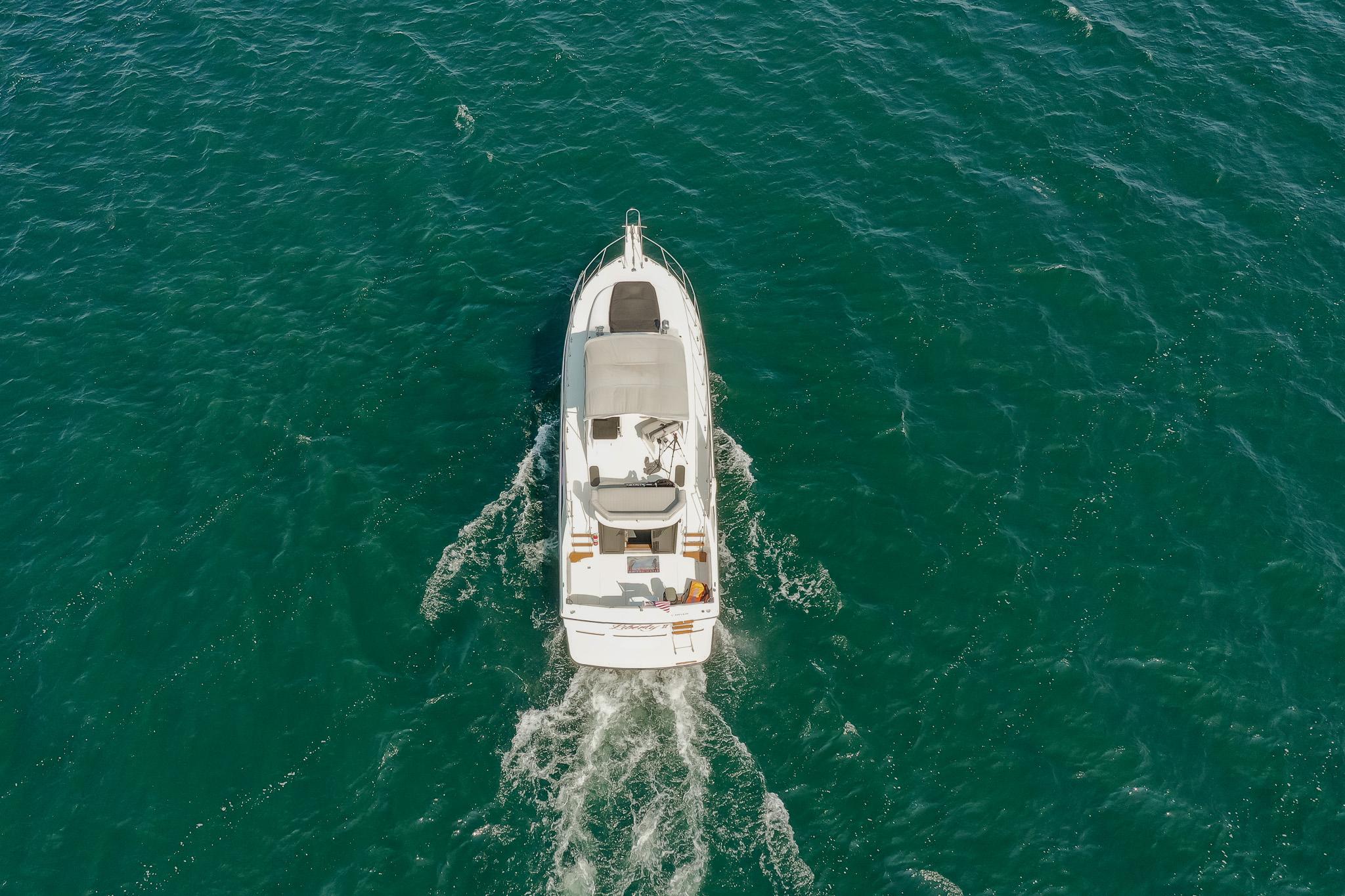 Aerial view of 1987 Carver 3697 Mariner cruising on open water.